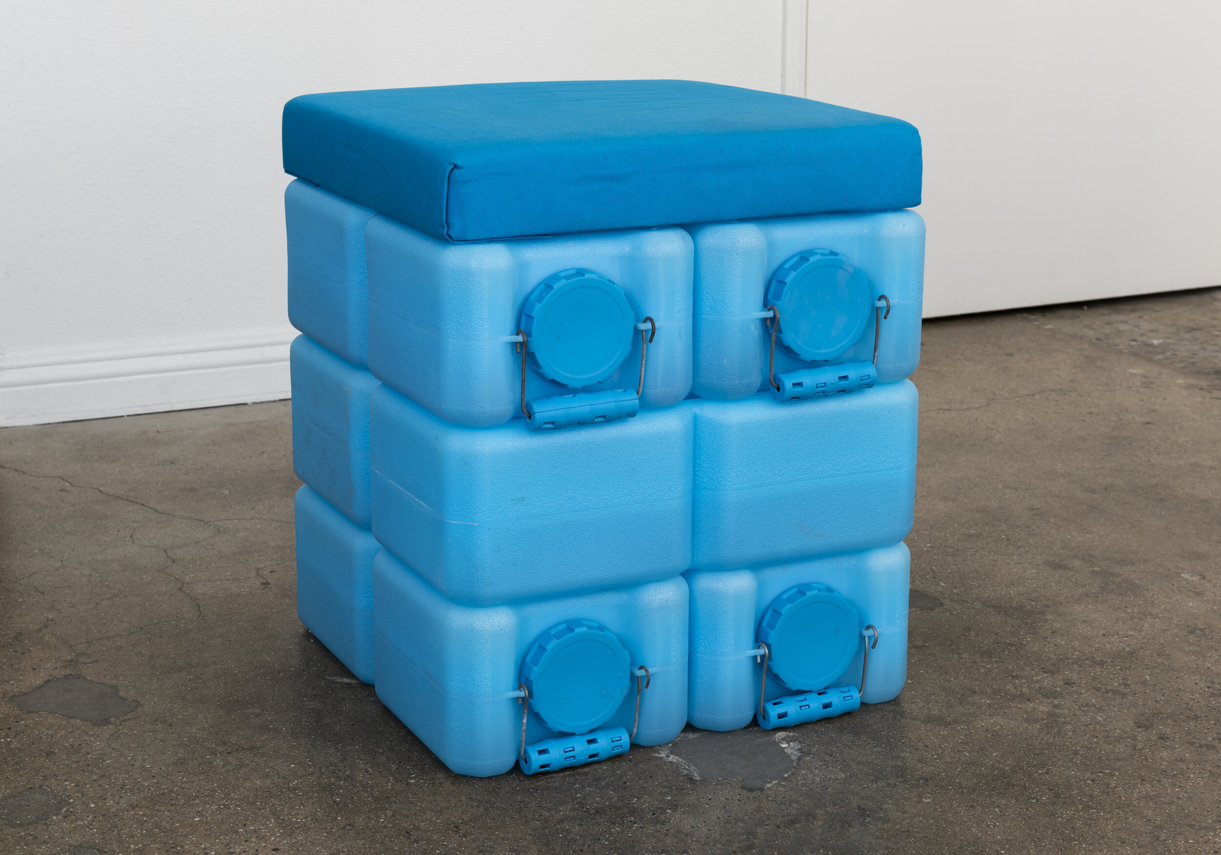   Colleen Hargaden   Water Brick (Ottoman)  2019 Water bricks, water, handmade upholstered panels 18 x 18 x 21 inches  Photo by Ruben Diaz 