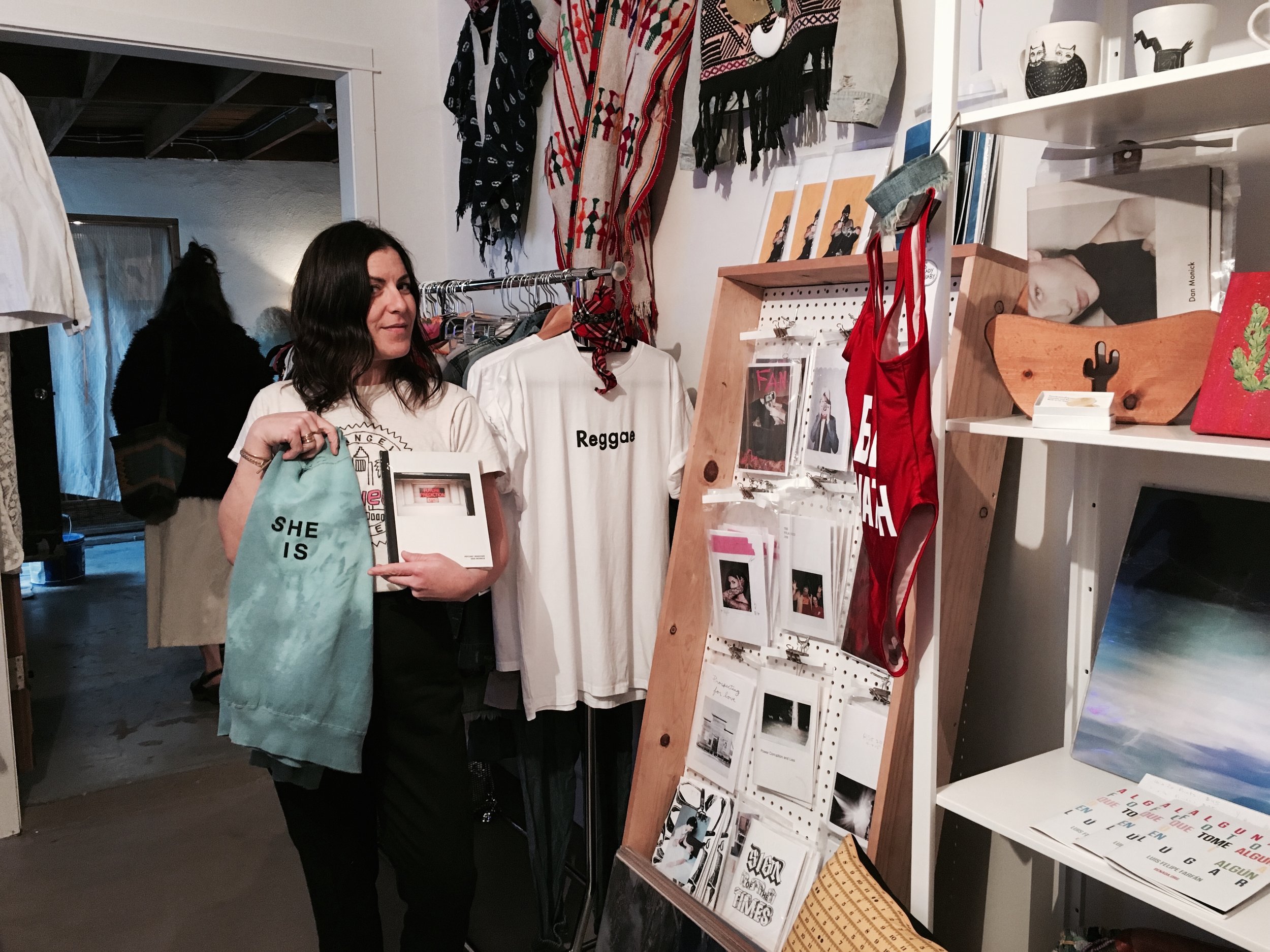 Lauren Shapiro, Costume Designer and Wardrobe Stylist of the Late Late Show, purchases a hard copy of Dan Monick's Psychic Windows and Masculine de La FEMME's "SHE IS" vintage sweater