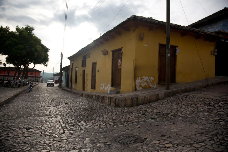 Al ver lo estrecho de las aceras en Comitán, se acuerda de la descripción en los cuentos de Ciudad Real, que el derecho de caminar en ellas era reservado para los ladinos, no para los indígenas.
