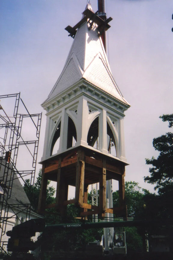 The reconstructed bell tower ready to be lifted back on to the church.