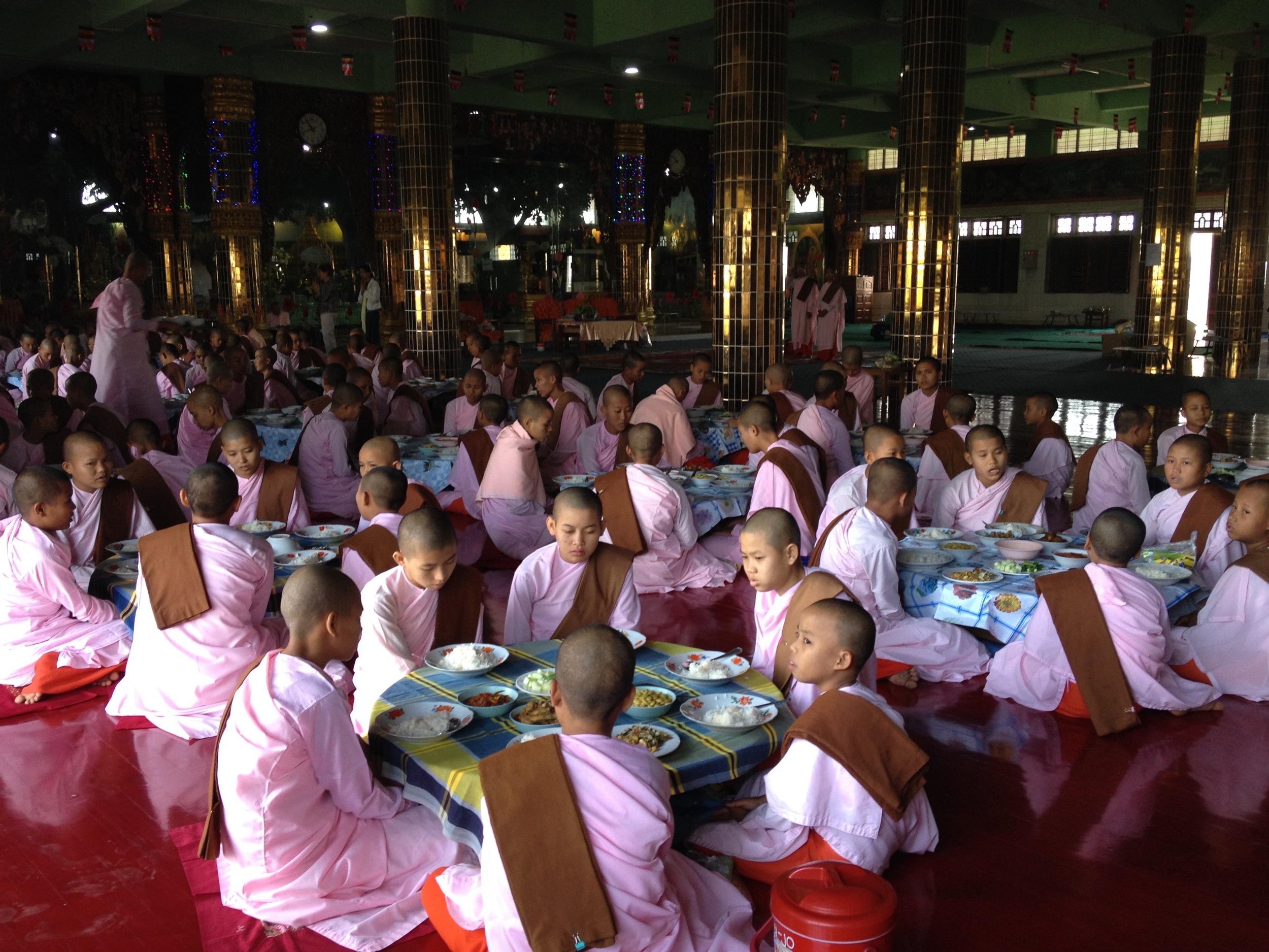 "Get we to a nunnery!" Buddhist nuns sit down for their main meal of the day, which, on this day, was supplied by a Chinese donor. Yes, it is typical for the Buddhist nuns to shave their heads just like the monks. In fact, it is often hard for us to tell them apart with no hair and robes covering all the distinguishing body parts.