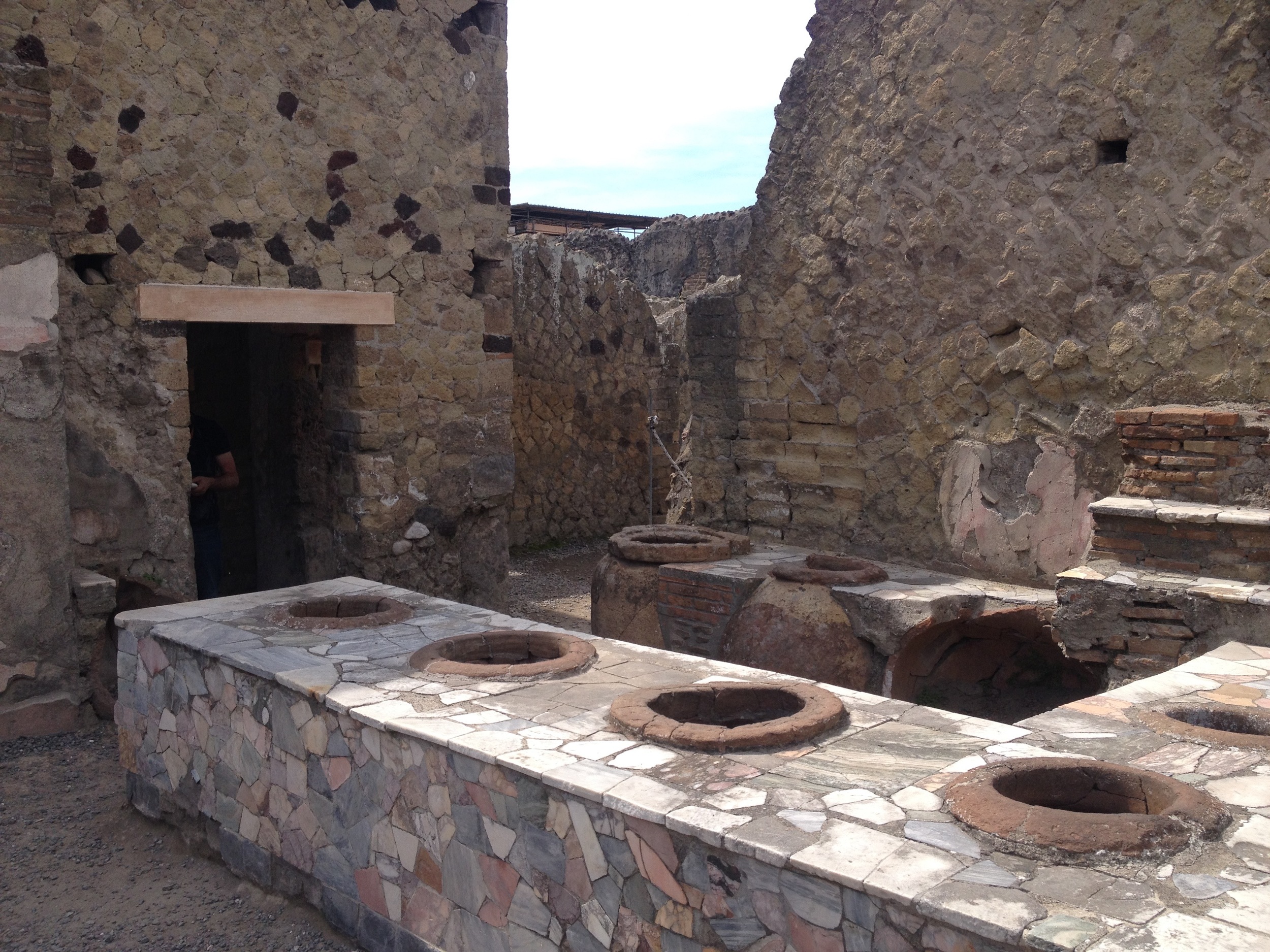 We complain about the ubiquitous fast food stands, but even in the years BC, fast food places were everywhere. Above is one of many snack bars in Herculaneum, the various large urns built into the counters no doubt serving up the Big Macs and french fries of the day.