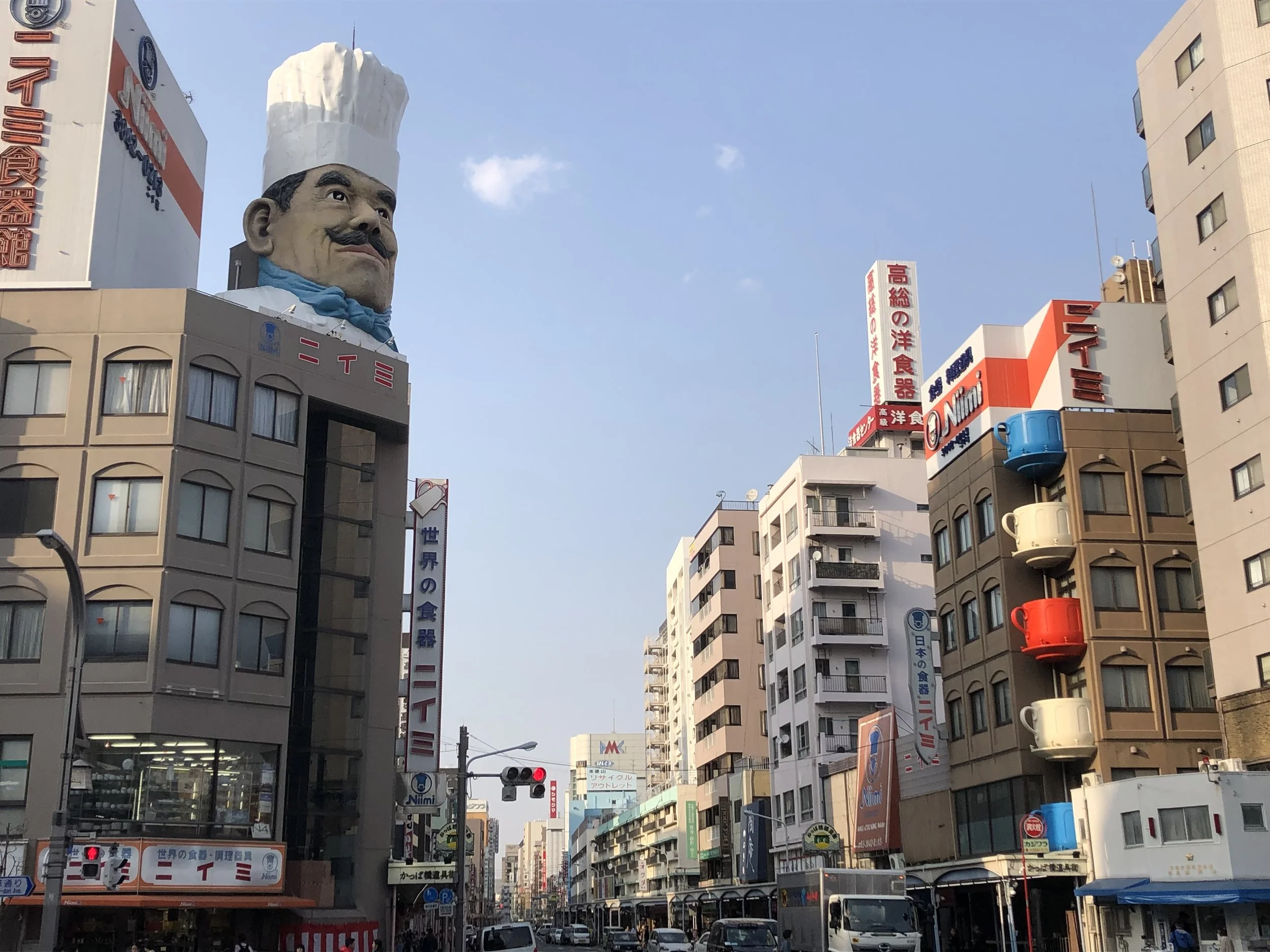 A stoic guard chef greets us at the entry to Kappabashi street. Bill goes shopping for Japanese knives.