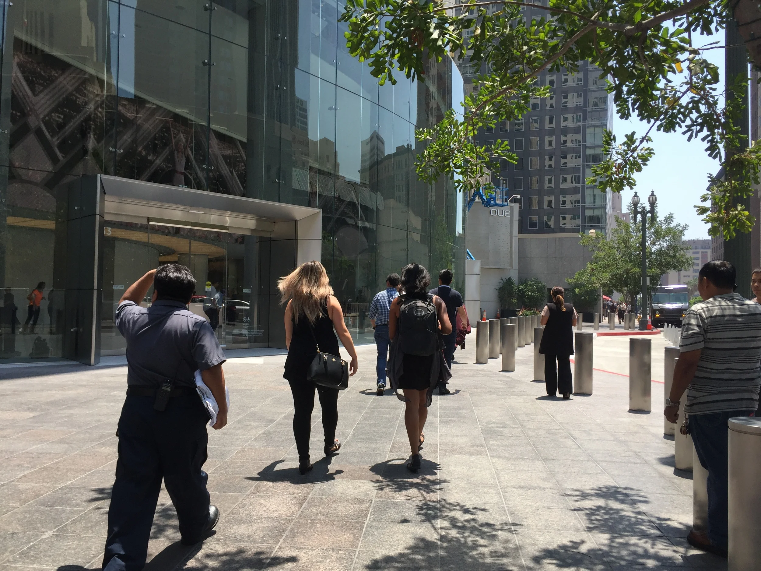 Pedestrians squeeze between the bulging lobby facade and a new vehicle drop-off lane. (photo by David Douglass-Jaimes)