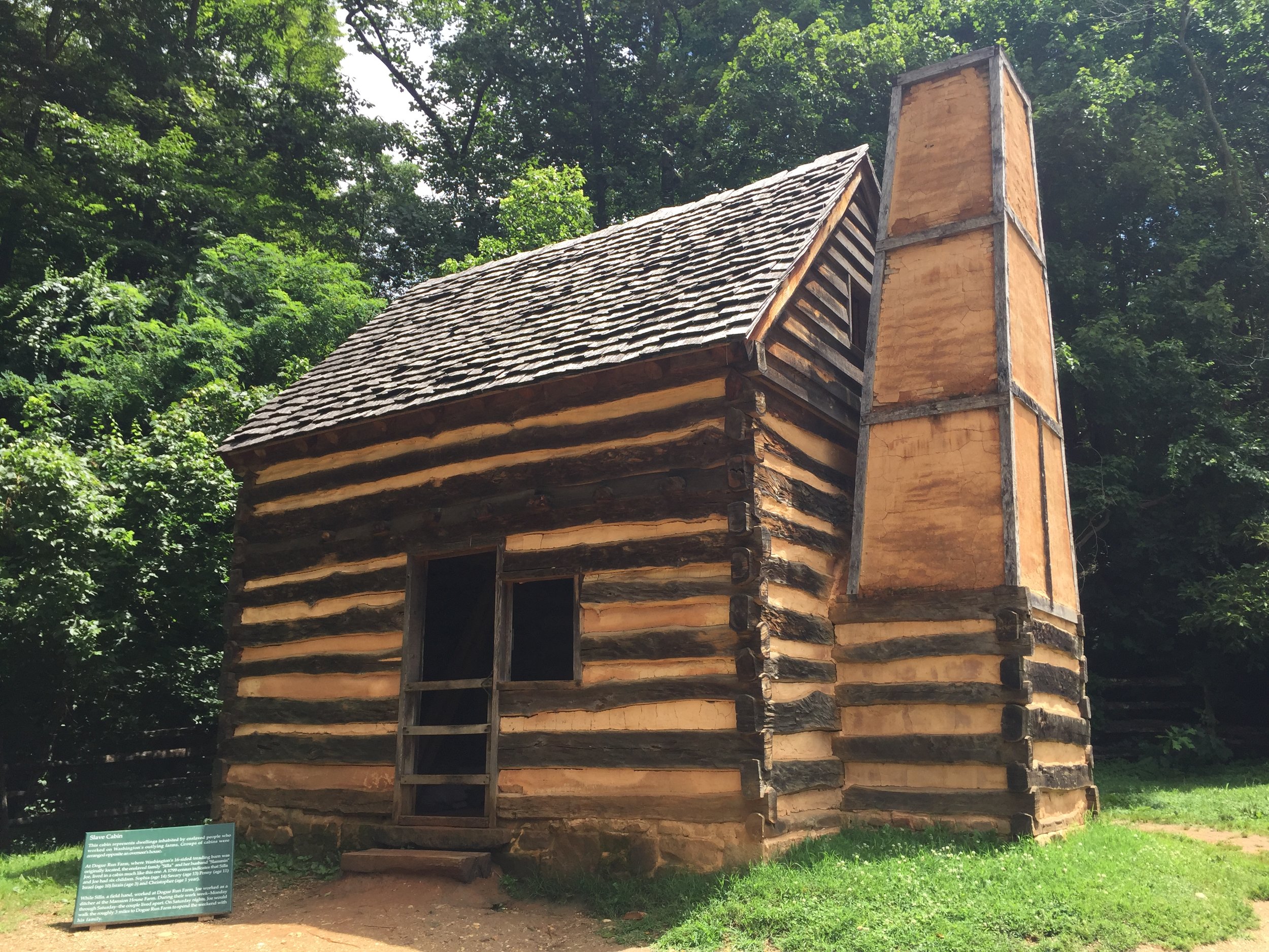 A reconstructed slave cabin at Mount Vernon. The sign near the cabin describes how a family of eight lived in a cabin like this one.