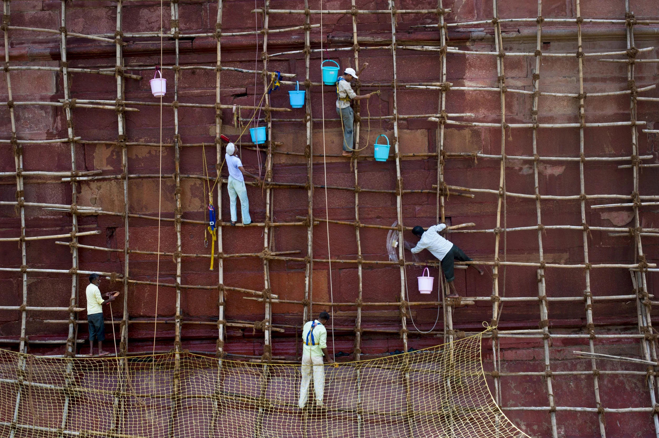   Workers clean the walls of the Red Fort, the residence of the Mughal emperor of India until 1857 and a symbol of India's independence, in Old Delhi on July 14, 2015.  