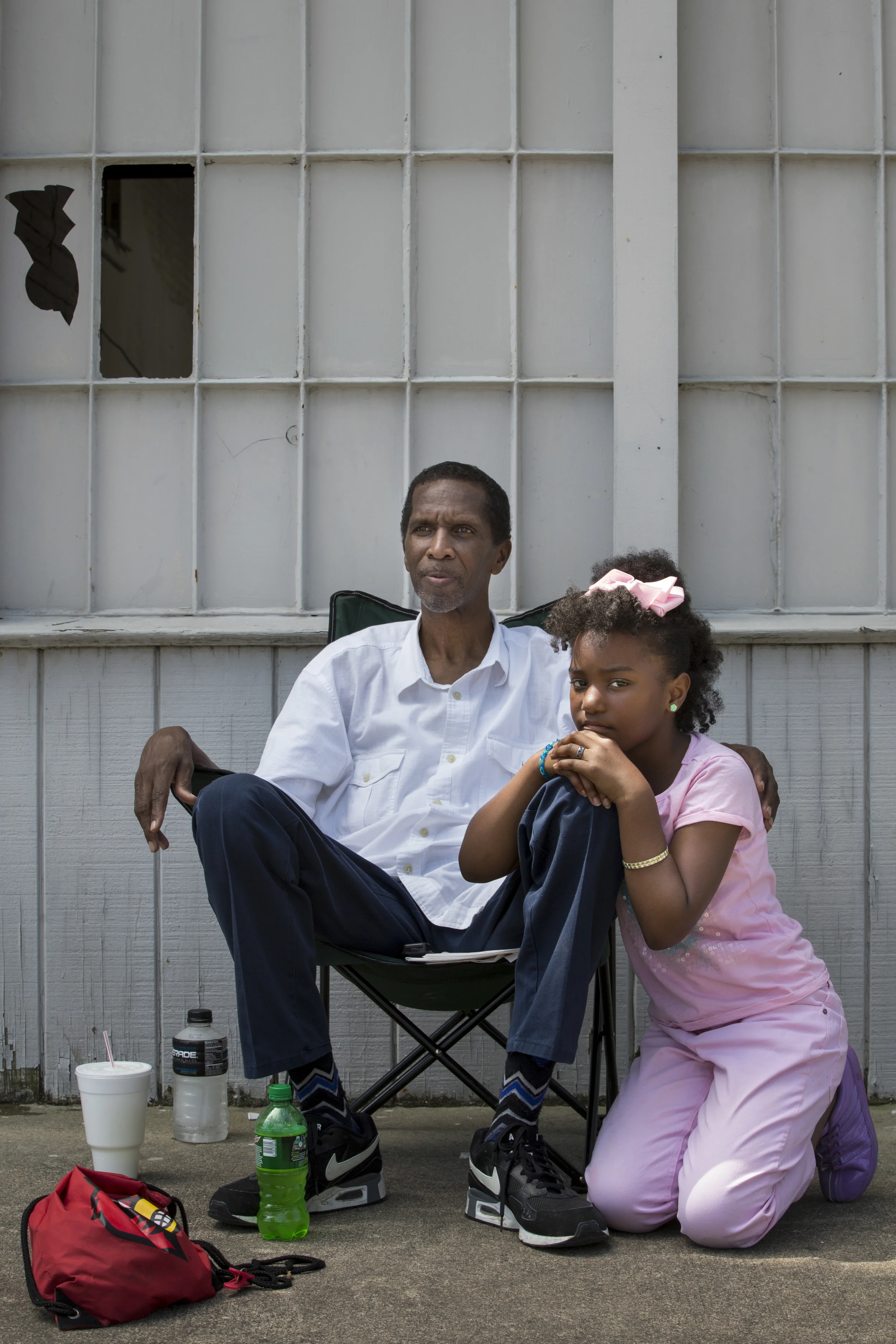  Donald Golightly and Jayla Hall, 9, wait along Broadway in Smoketown for the passing of Muhammad Ali's procession in his hometown of Louisville on June 10, 2016. Both are members of the Cable Baptist Church and came down with members of their congre