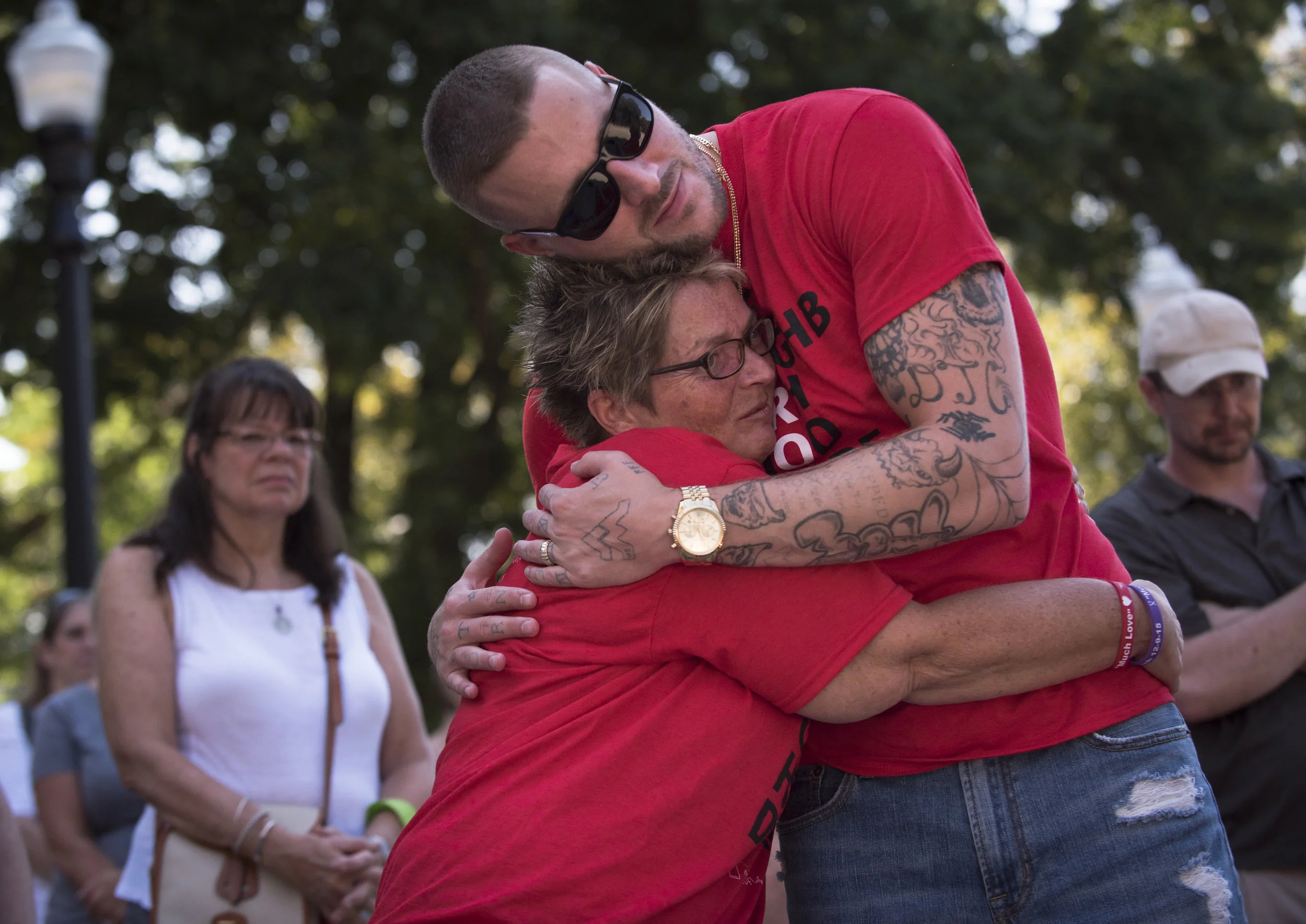 Justin Ponton embraces Sue Ellen Chapman after she spoke of her late son Andrew Harrison Hutchison "Hutch The Dutch" in front of a crowd of hundreds at the West Virginia Overdose Awareness Day Tribute at the State Capitol in Charleston, WV on August 27, 2016. Ponton is the director of the 9th Avenue Newness of Life recovery lifehouse. 
