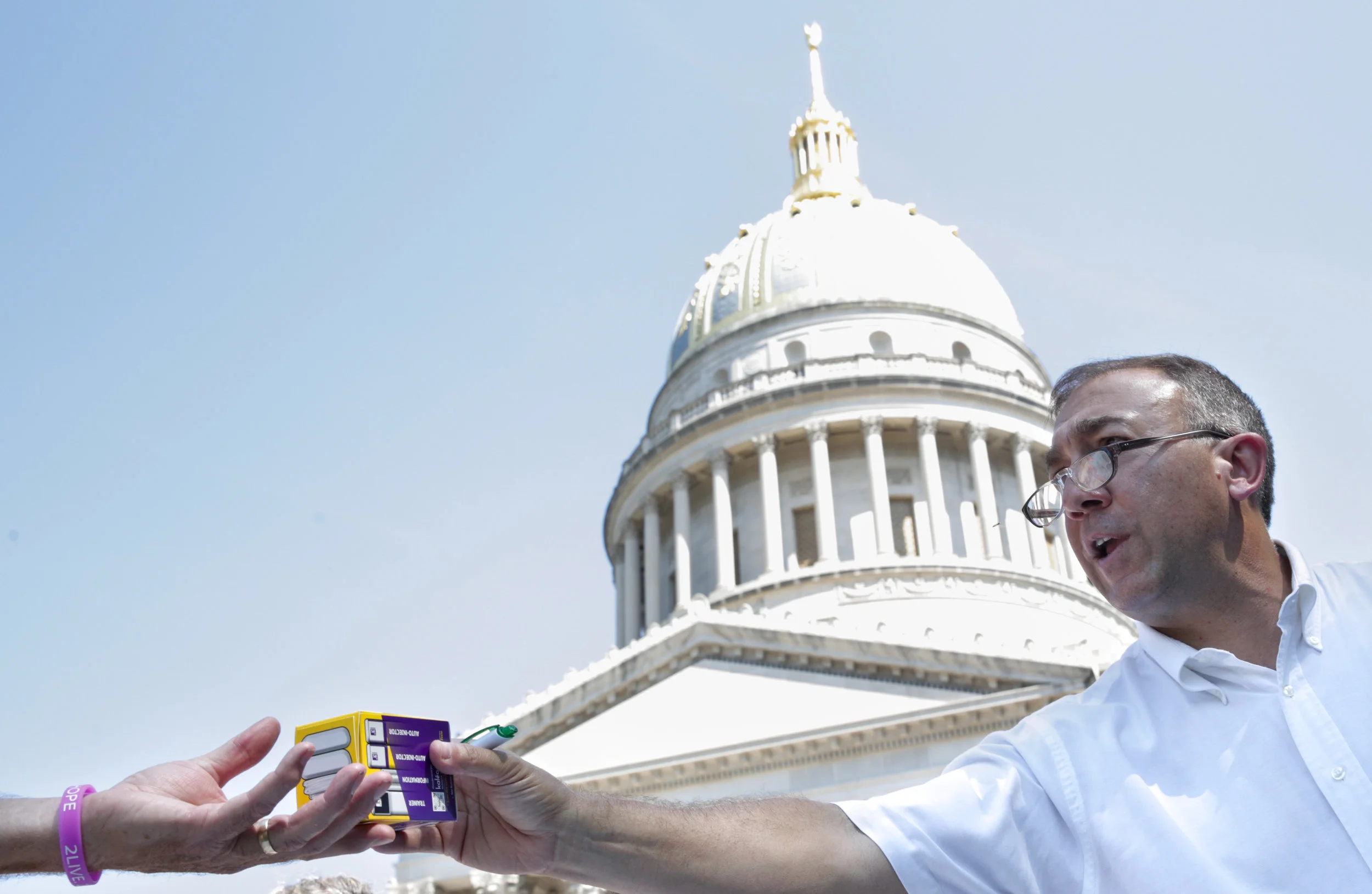 Dr. Michael Brumage of the Kanawha-Charleston Health Department distributes naloxone adminstration for free to a crowd of people at the West Virginia Overdose Awareness Day Tribute in Charleston, WV on August 27, 2016. The life-saving drug, while offered over-the-counter, is often too expensive to buy without a prescription.