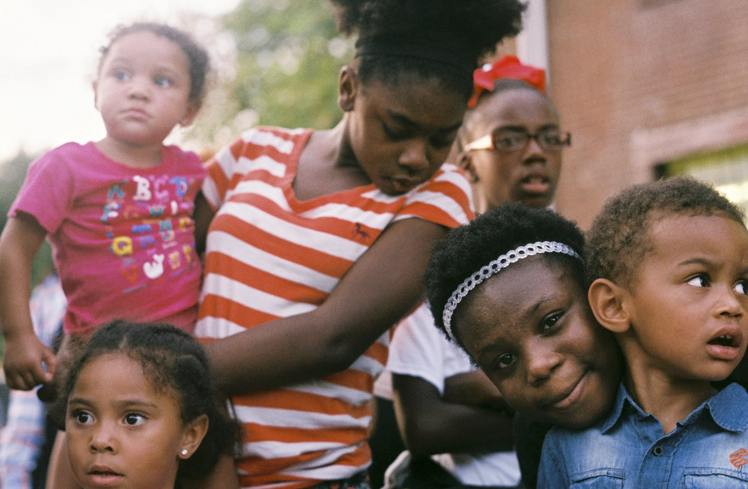 Children watch the River City Drum Corp perform at the Smoketown Get Down for Democracy on September 16, 2016.