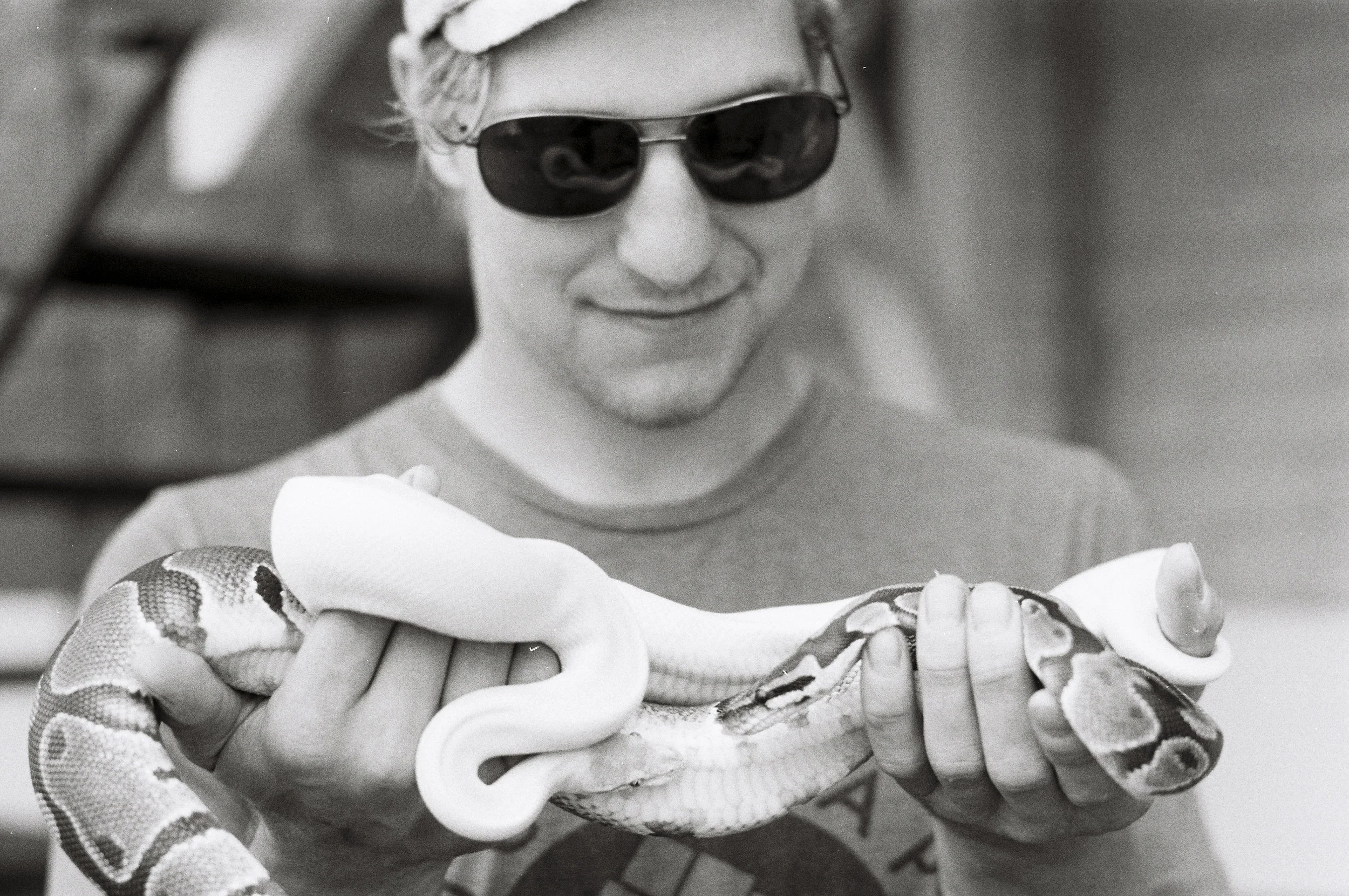 Michael holding two snakes on Court Street. Athens, OH.