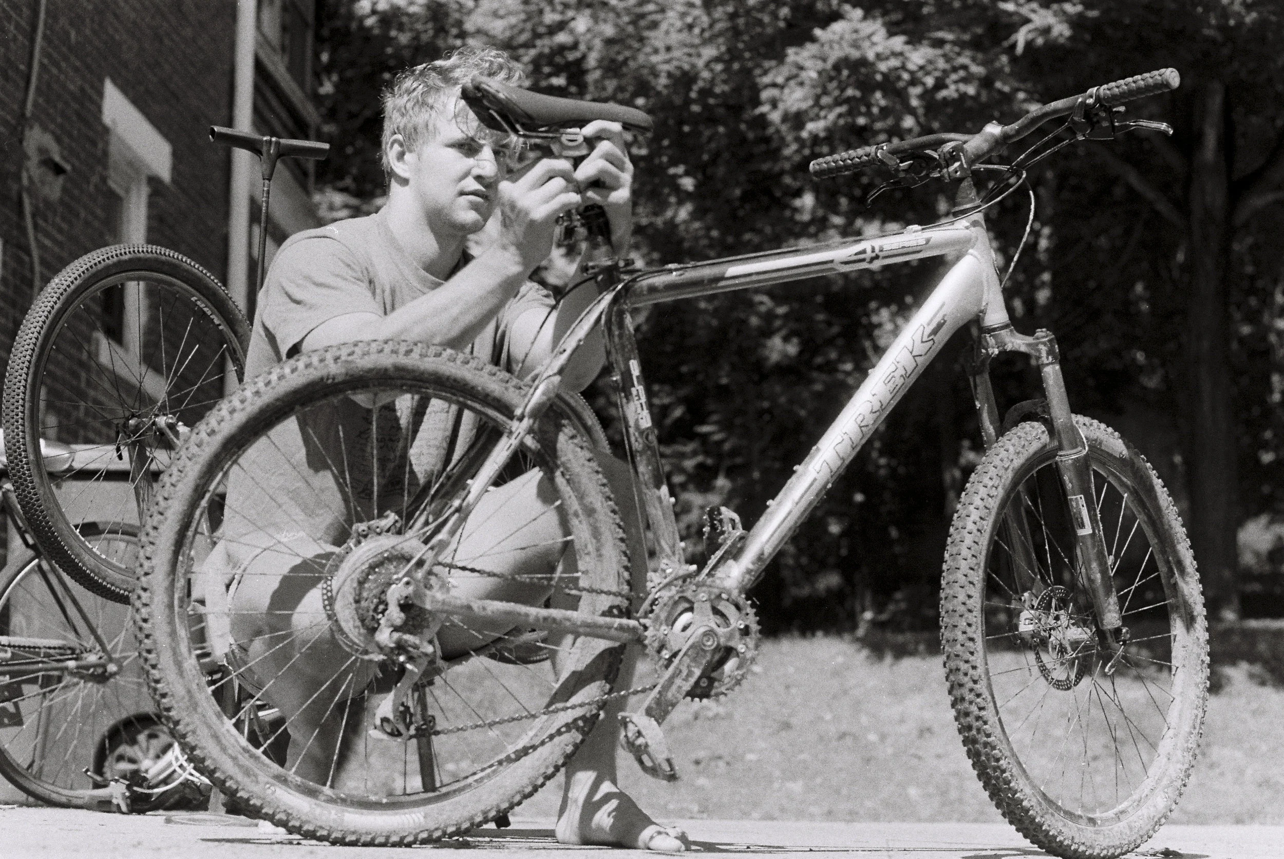 Michael adjusts his mountain bike before a morning ride. Athens, OH. My bike chain broke 1/4 mile onto the trail, so we took a swim in Strouds Run instead.