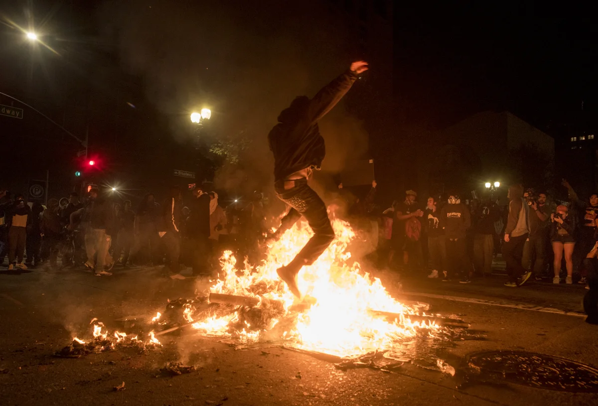 Protesters burned trash cans and spray painted building facades of downtown Oakland late into the night in protest of President-elect Donald Trump on November 9, 2016.