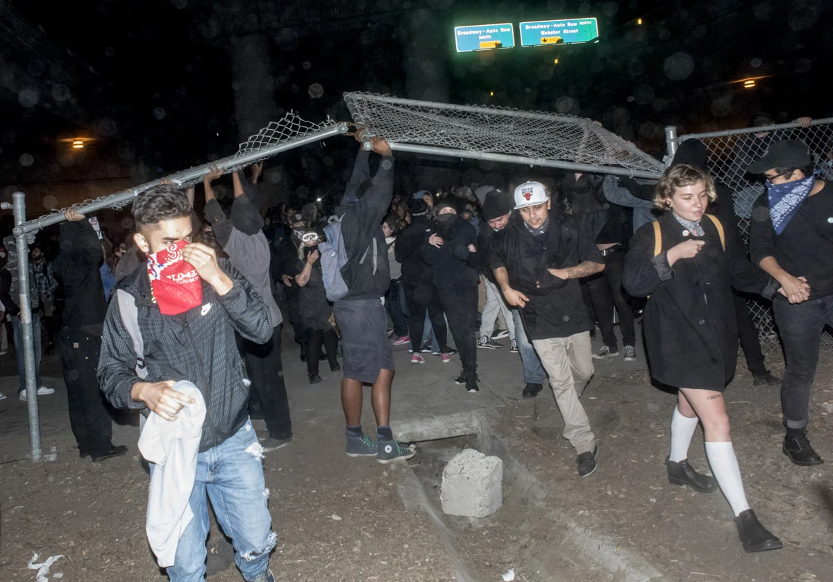 President-elect Donald Trump protesters broke through freeway fencing and attempted to take Interstate 580, but were stopped by riot police in downtown Oakland on November 10, 2016.