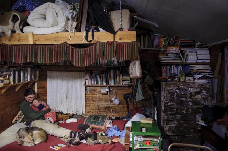  Anne Badger hugs her son Linden Badger in their home at the Susan B. Anthony Memorial Unrest Home, a women's intentional living community in Athens, Ohio, on February 13, 2014. Anne and her partner Liz have lived at SuBAMUH for five years. 