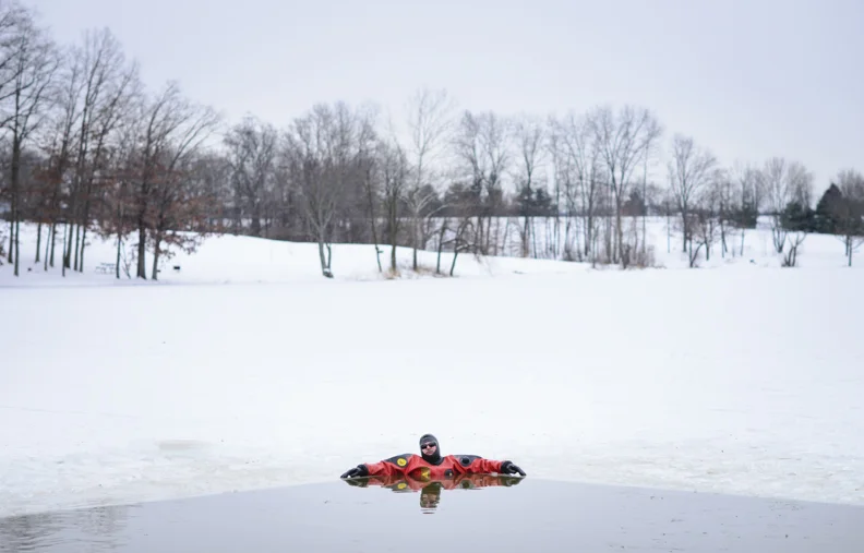  Doug Boudinot, a member of the Athens County Specialized Response and Recovery Unit, rests in the below freezing waters of Lake Snowden in Albany, Ohio in preparation for the Athens Polar Plunge, a fundraiser for the Special Olympics. 