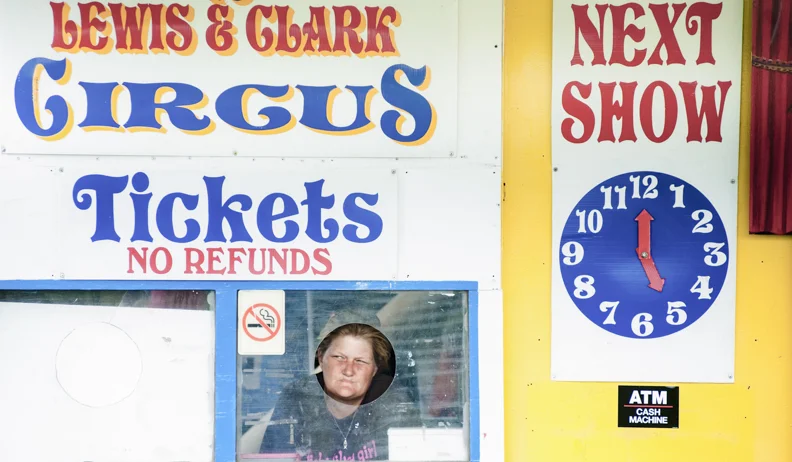  The ticket attendant waits for customers at the Lewis &amp; Clark Circus, a traveling entertainment company, in Butler, PA 