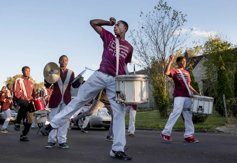 Linden-McKinley senior snare drummer Jeff Floyd, middle, dances during a cadence alongside fellow snare drummer Jayshone Garland, senior, right, during the Linden-McKinley homecoming parade on Friday, October 16, 2015. The homecoming parade has alwa