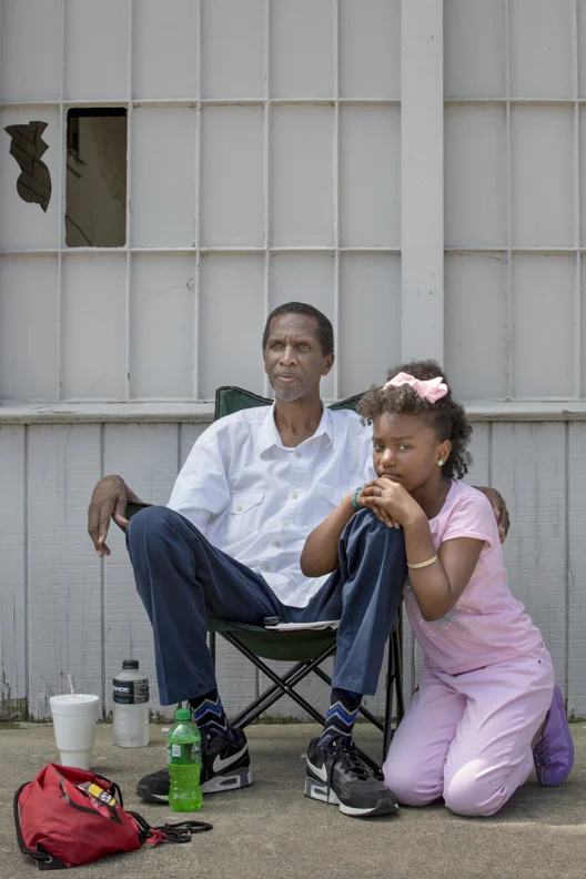  Donald Golightly and Jayla Hall, 9, wait along Broadway in Smoketown for the passing of Muhammad Ali's procession on June 10, 2016. Both are members of the Cable Baptist Church and came down with members of their congregation to witness the processi