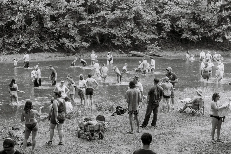  Patrons of the Nelsonville Music Festival wade in the Hocking River. Nelsonville, OH. 