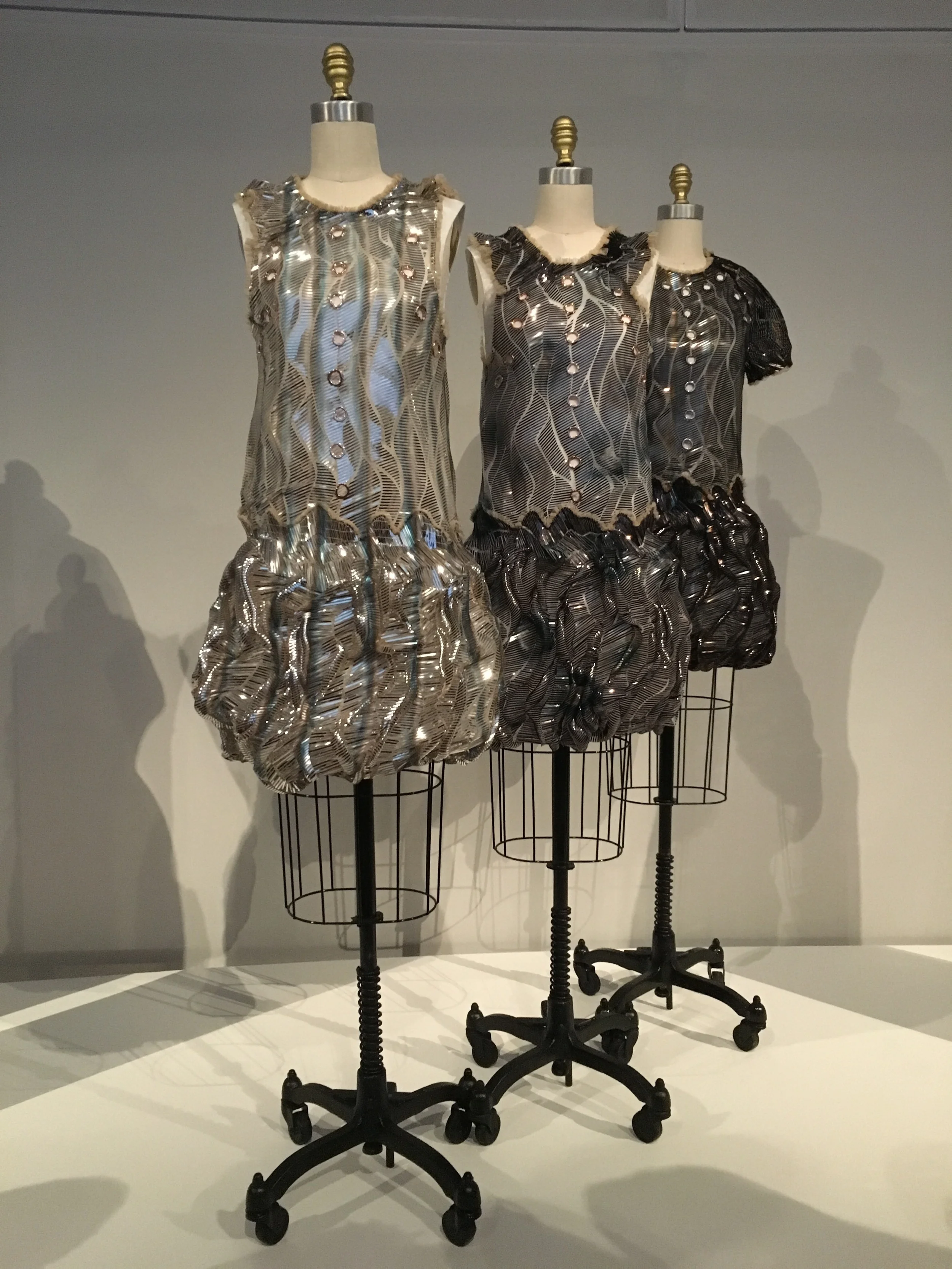 Louis Vuitton Co. Nicolas Ghesquiere SS 2016 prêt-à-porter Machine sewn white cotton poplin; machine-sewn , hand-appliqued overlay of ivory silk-synthetic net, bonded with laser-cut silver metallic strips, hand-airbrushed with black, dark brown, blue, and gray pigment, hard-grommented with copper metal