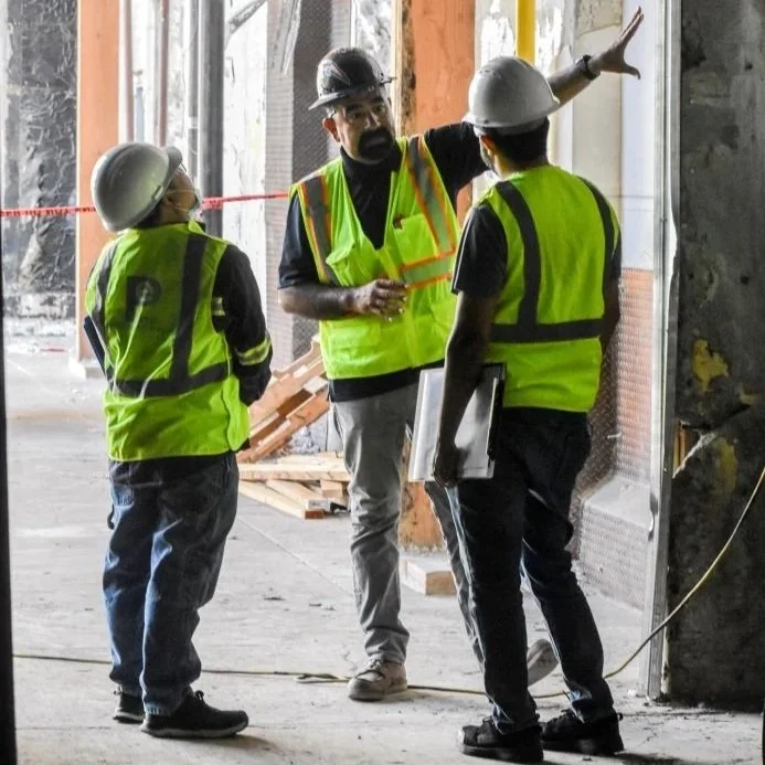 Three engineers from Plump Engineering inspecting a building's structural integrity