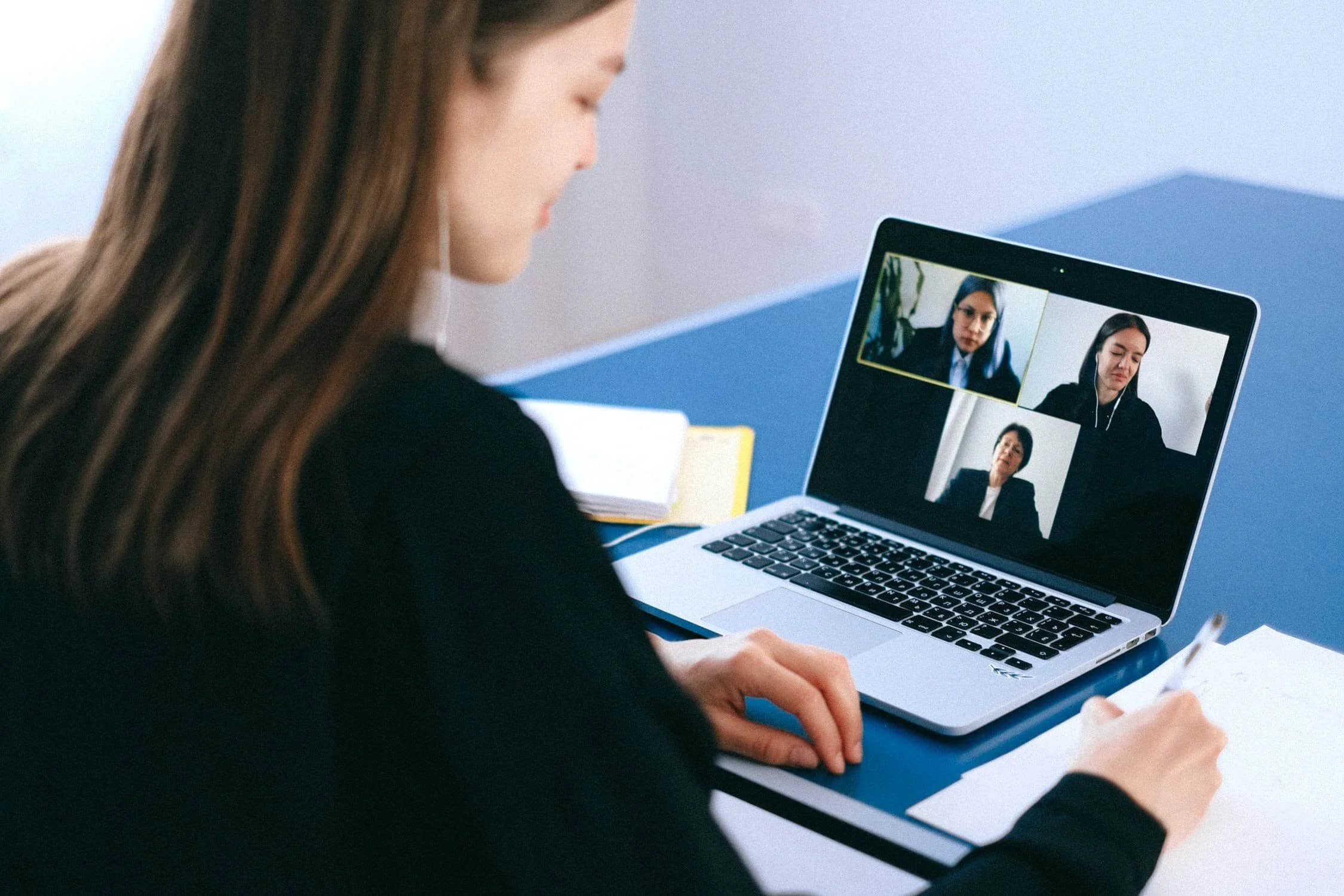 Lady on a video call with the laptop screen in front of her