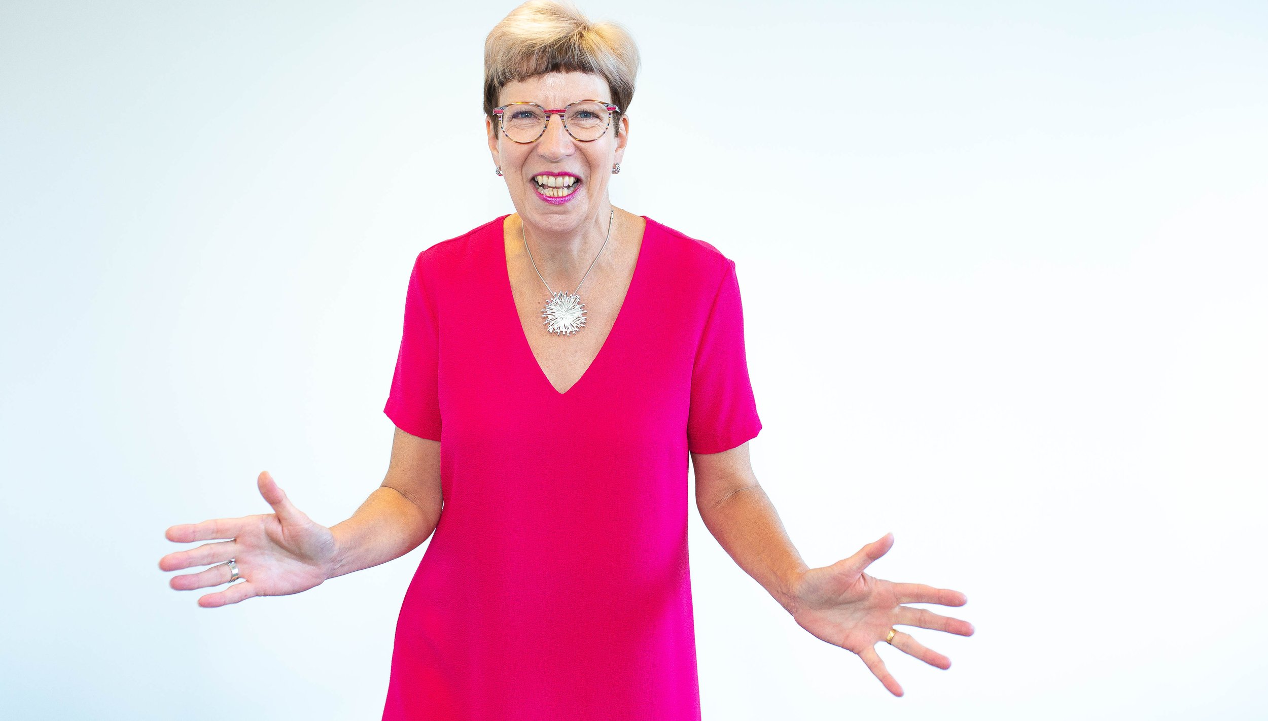 Posture expert Alison in pink top smiling and looking excited