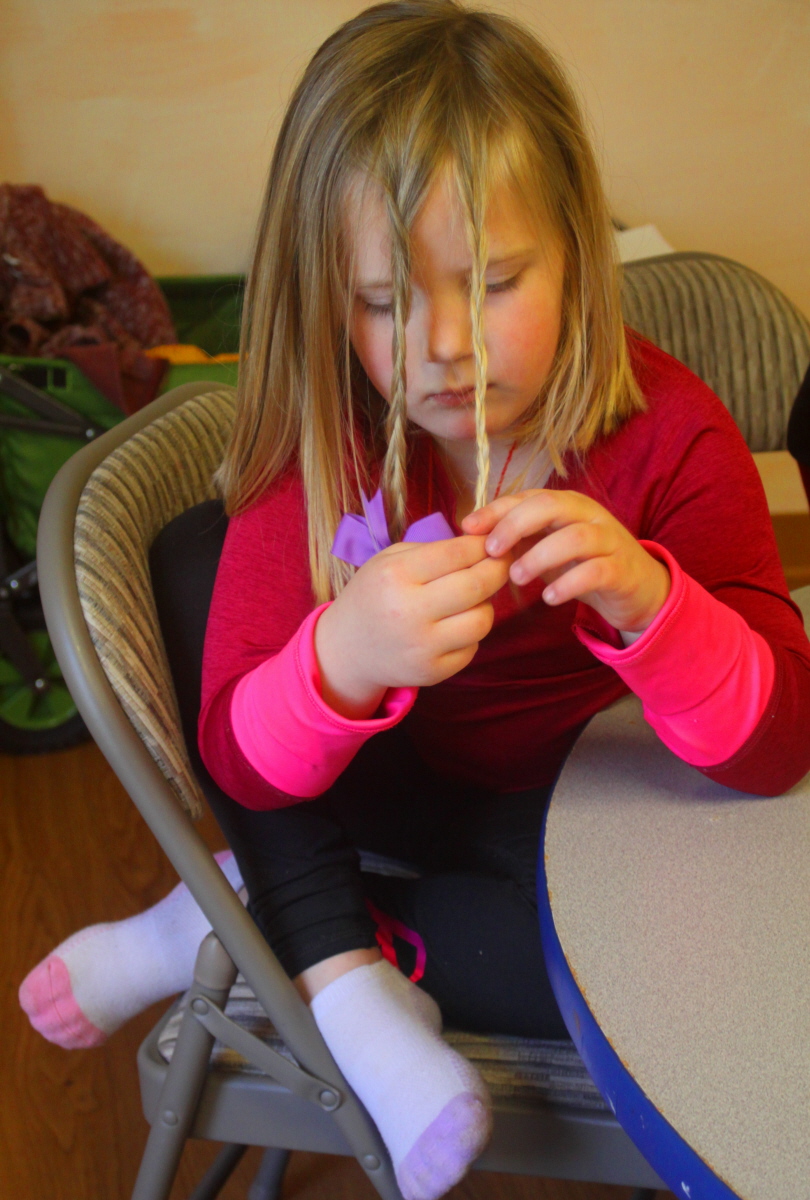 Braiding her own hair email.jpg