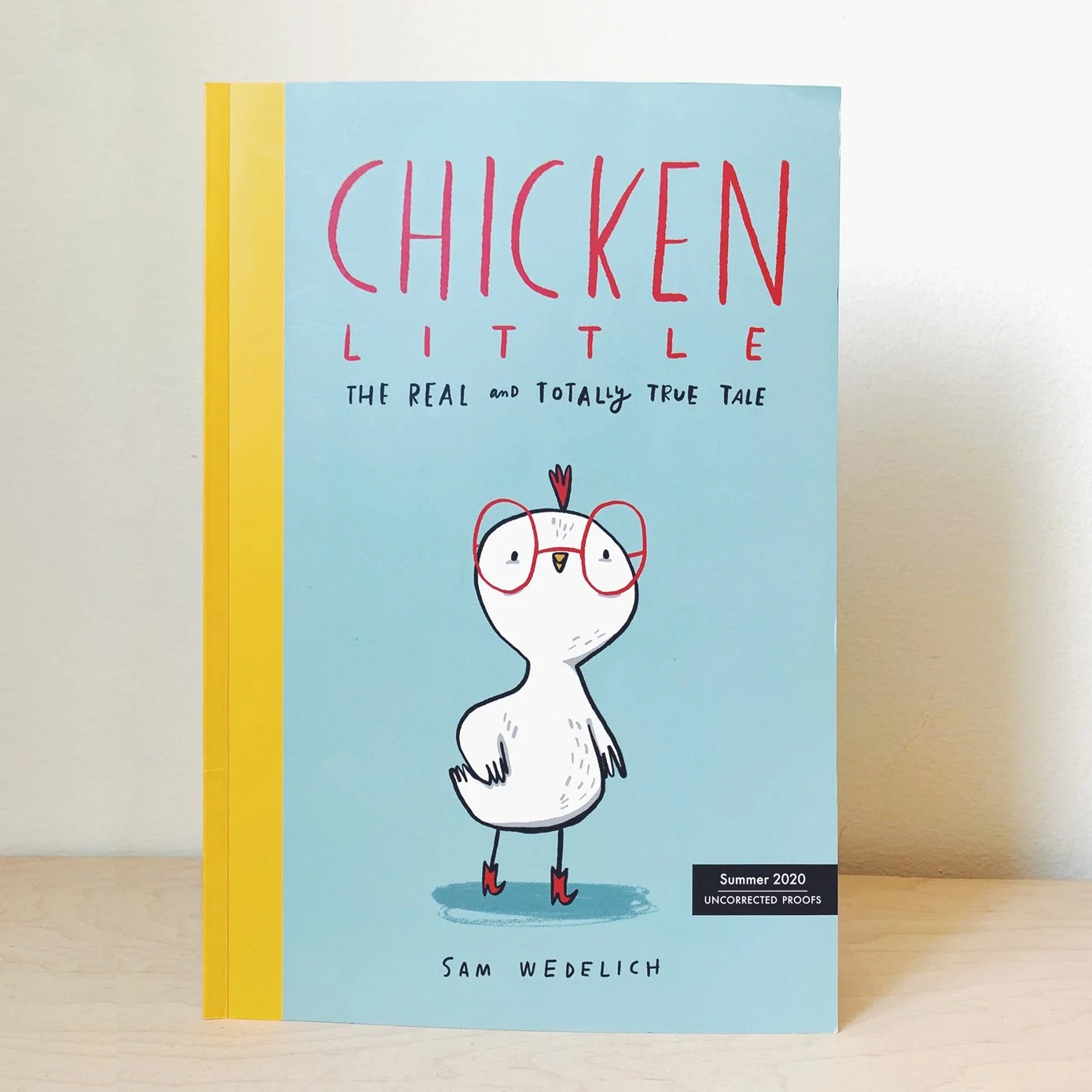 Cover of a book titled "Chicken Little: The Real and Totally True Tale" by Sam Wedlich, featuring a cartoon chicken with glasses and red shoes, set against a light blue background with a yellow spine.