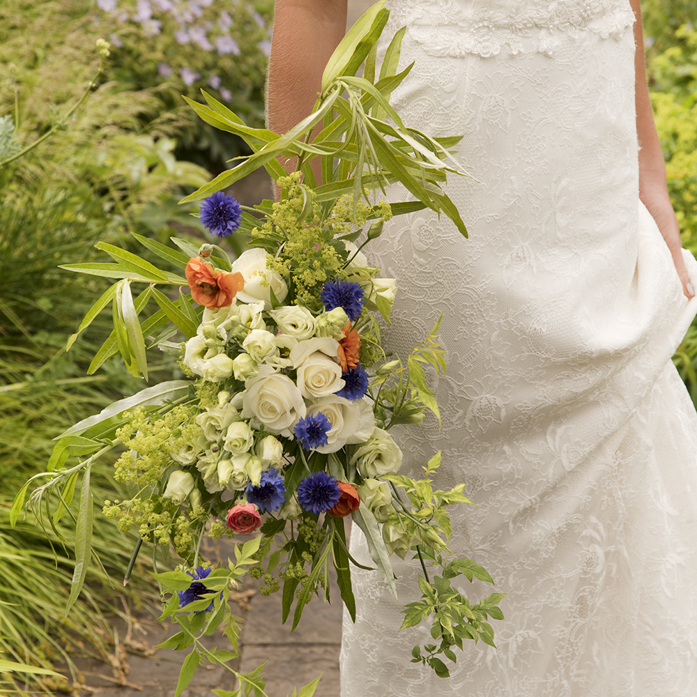 Natural bridal bouquet with red, white and blue flowers