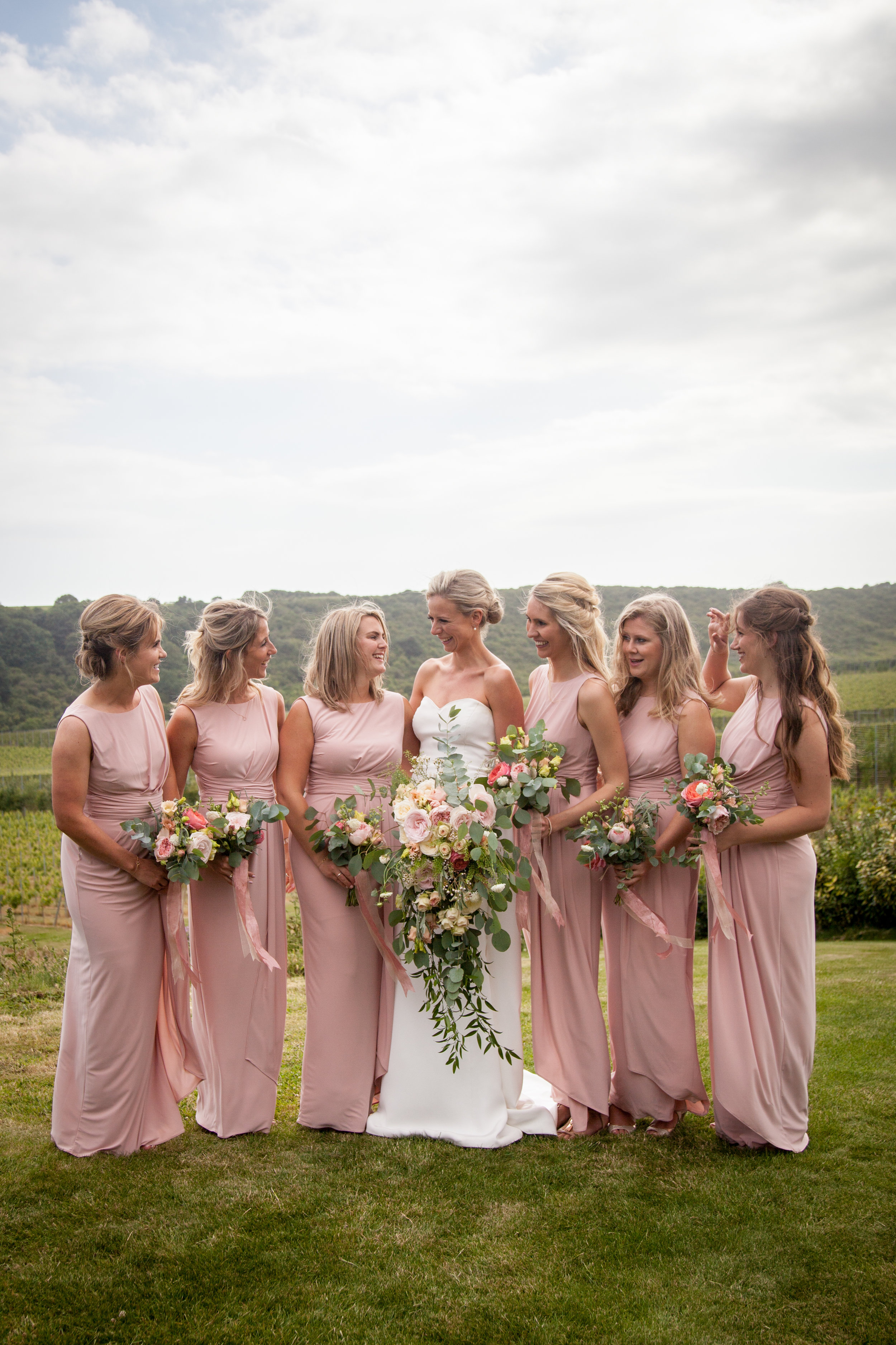 happy bride with maids and roses .jpg