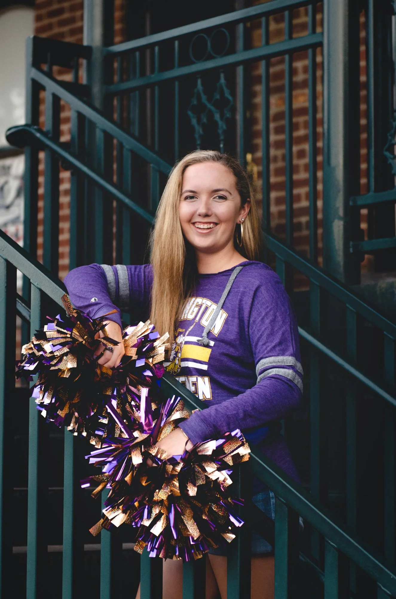High school senior standing with pom poms in Lexington, Ohio.
