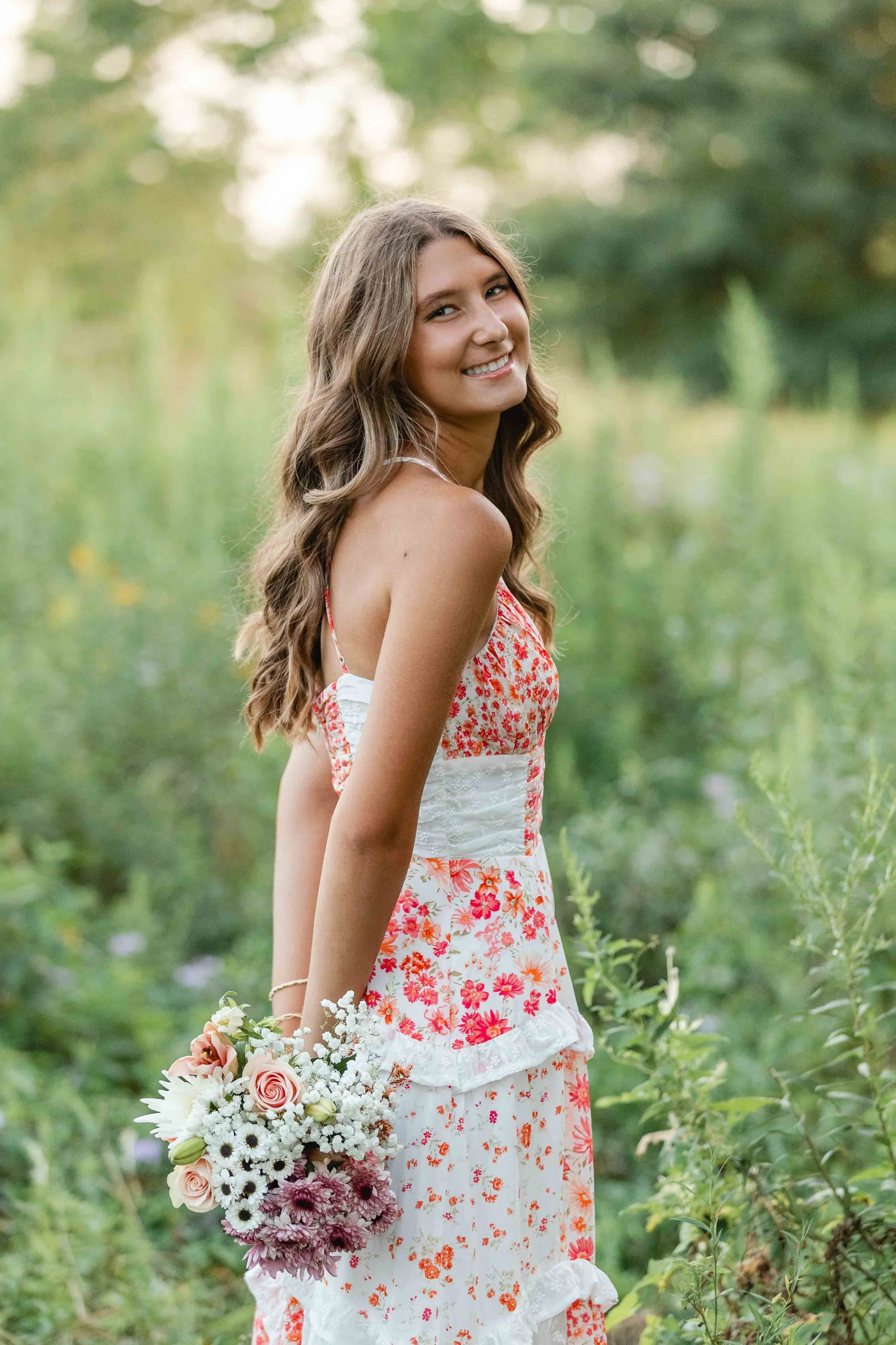 Outdoor senior photo with beautiful flowers.