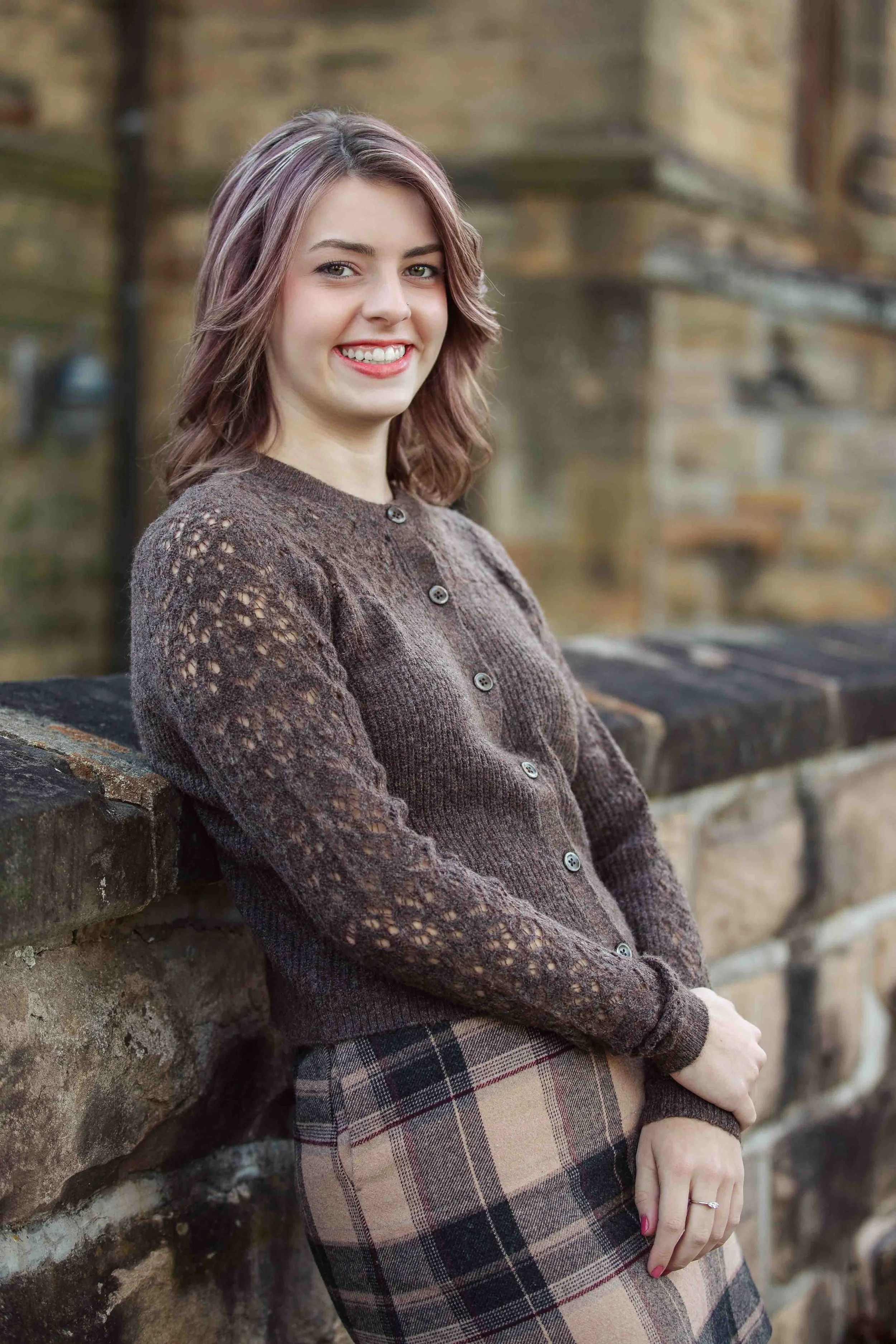 Senior Girl Leaning on Stone Wall During Golden Hour