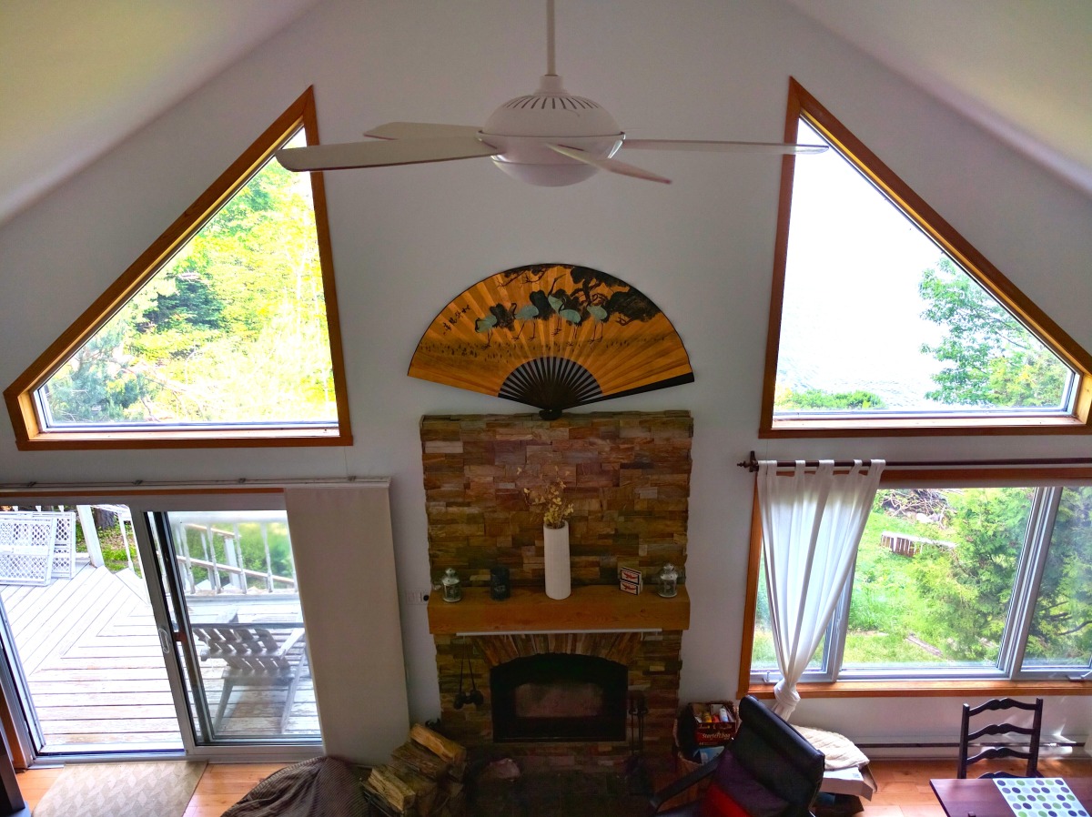 View of living room and fireplace from upstairs loft