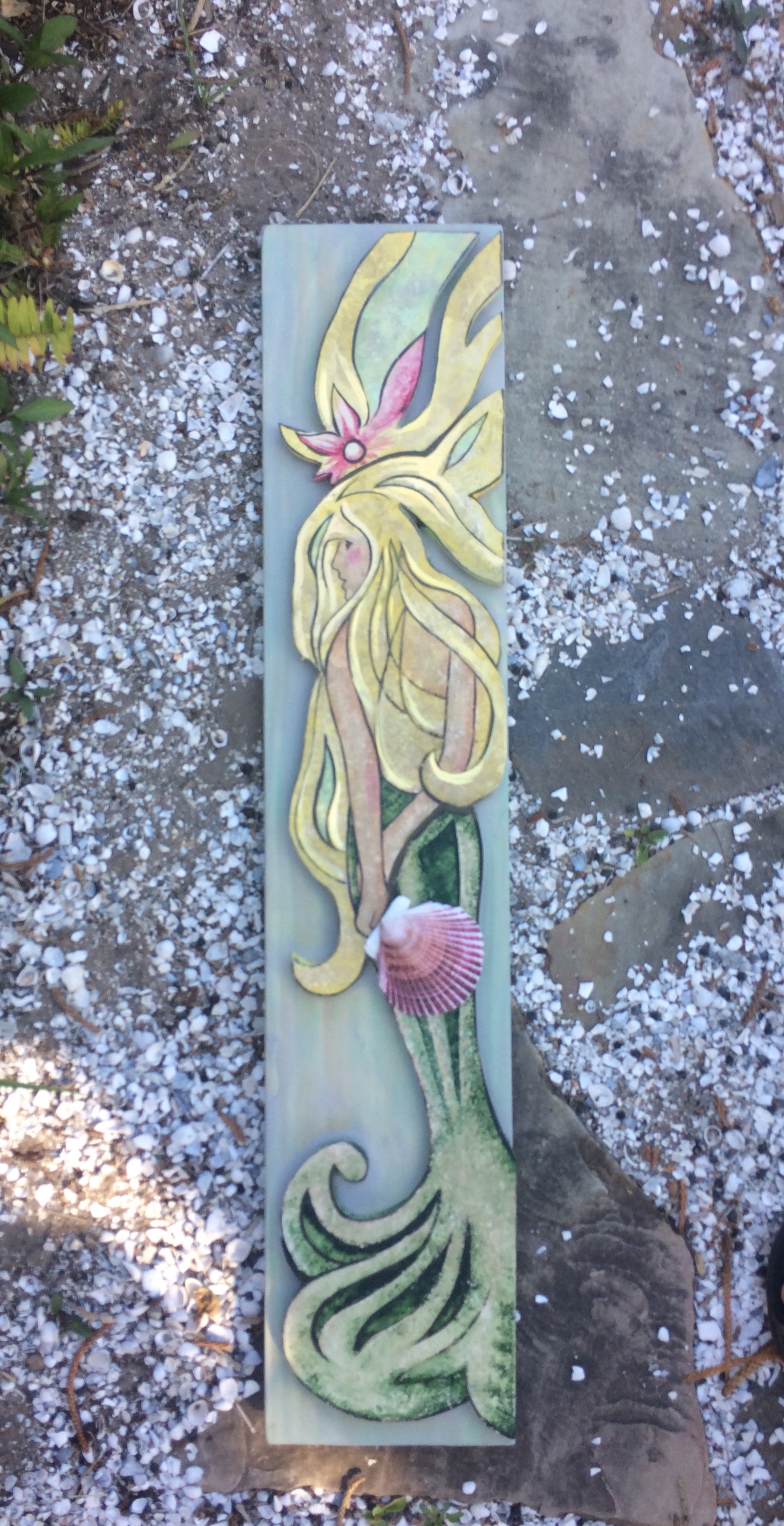 Springtime Mermaid.... painted on stone on grey blue pine board....3' x 7 1/4"