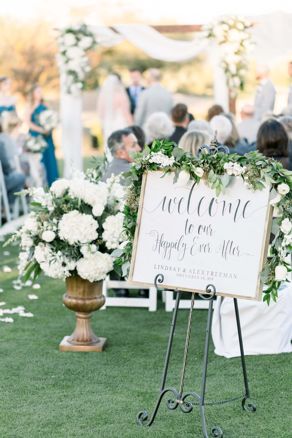 Wedding ceremony welcome sign and flowers at Gainey Ranch Golf Club in Scottsdale, Arizona