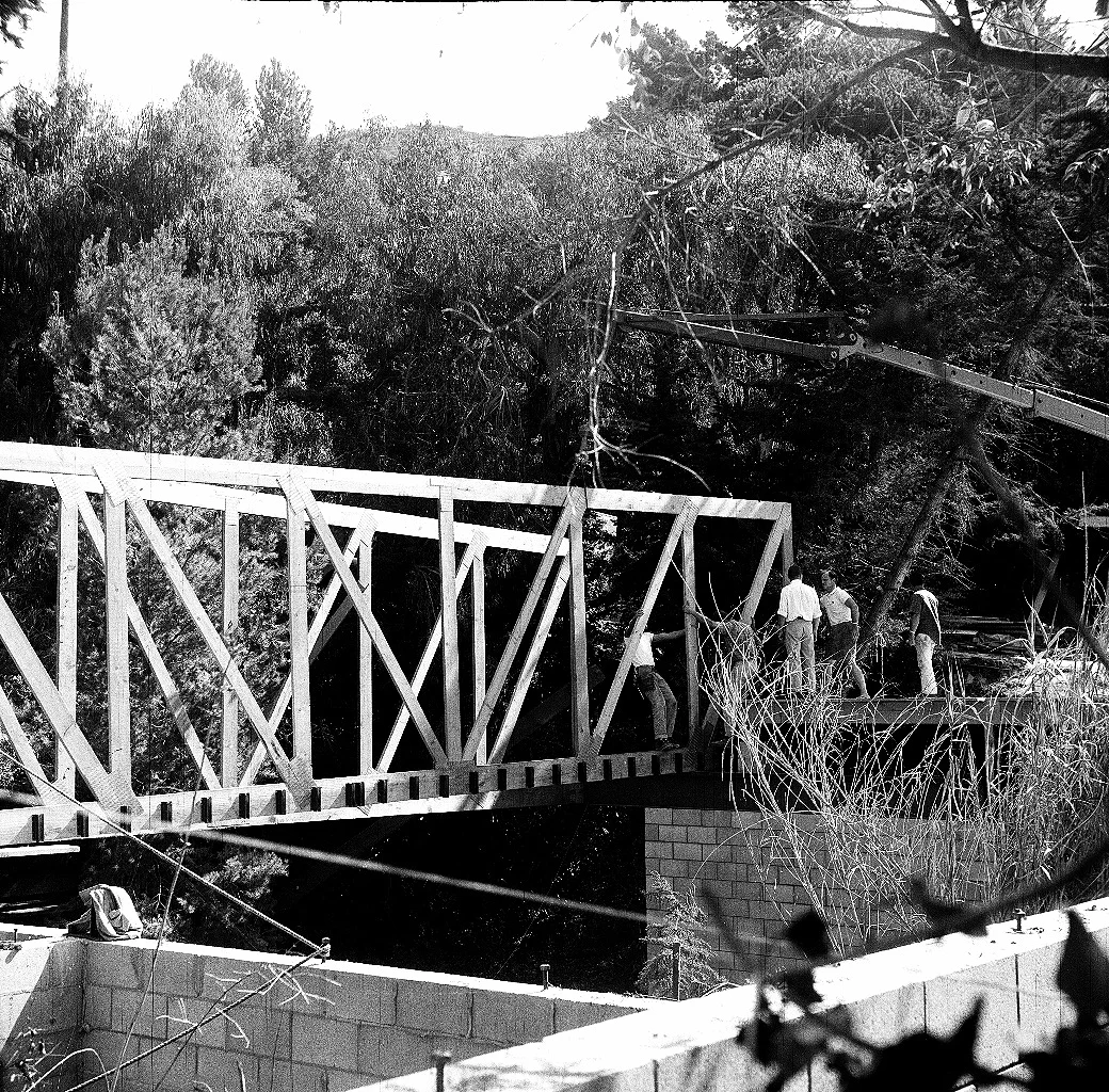 Here they are setting the second truss. The stream runs right under the house.