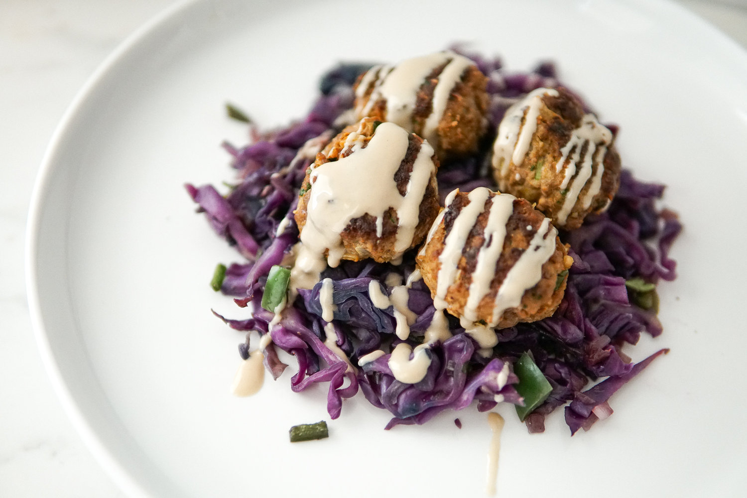 Moroccan spiced meatballs drizzled with tahini