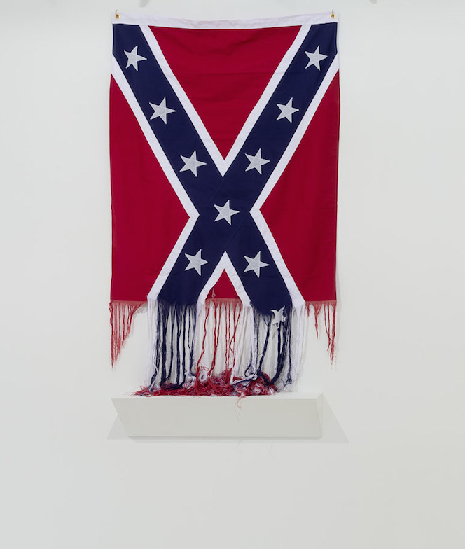 Sonya Clark, Unraveled Confederate Flag as shown in Mixed Greens Gallery (NYC), Photo Credit: Hyperallergic