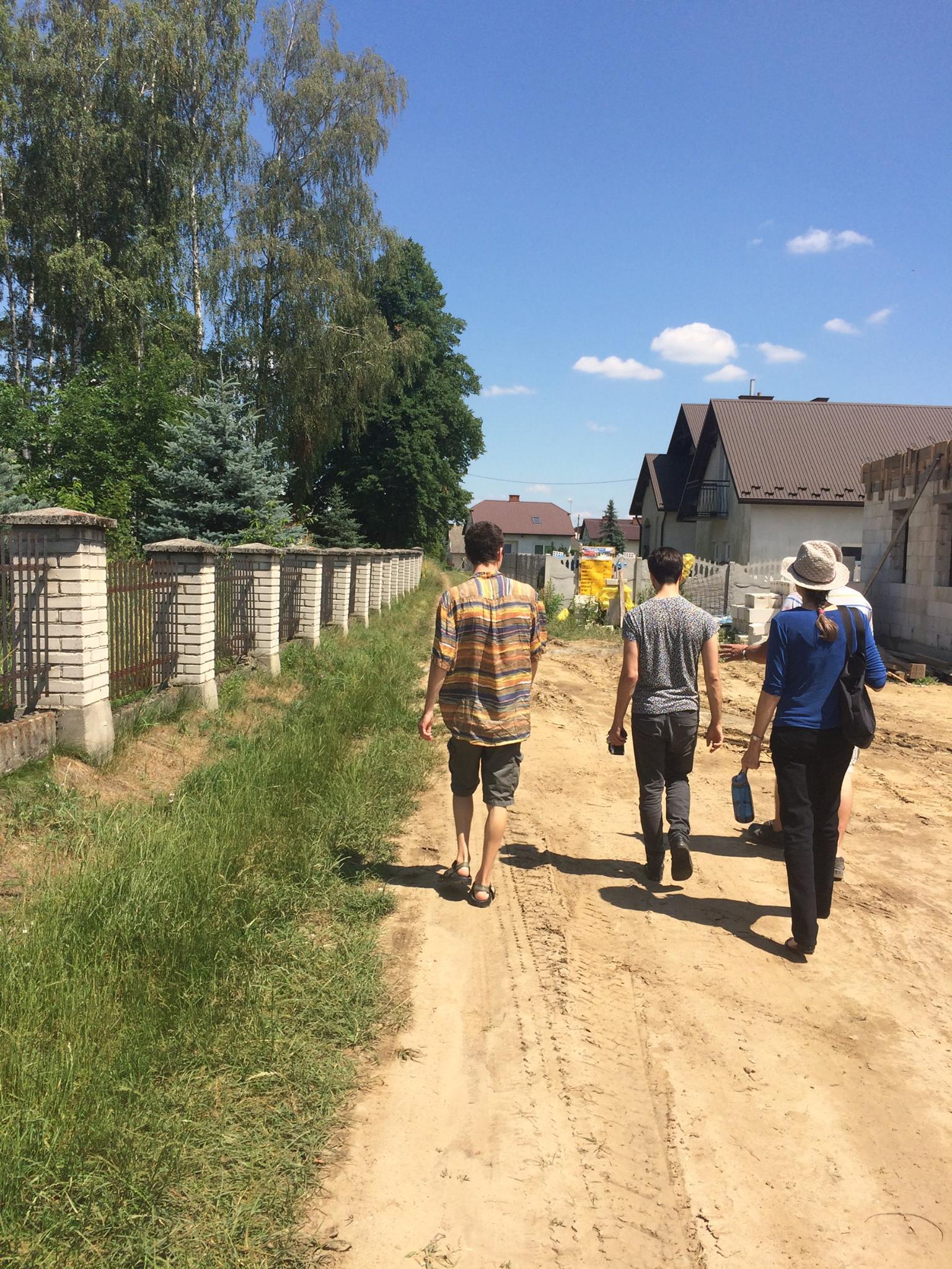 Walking down dirt road to cemetery