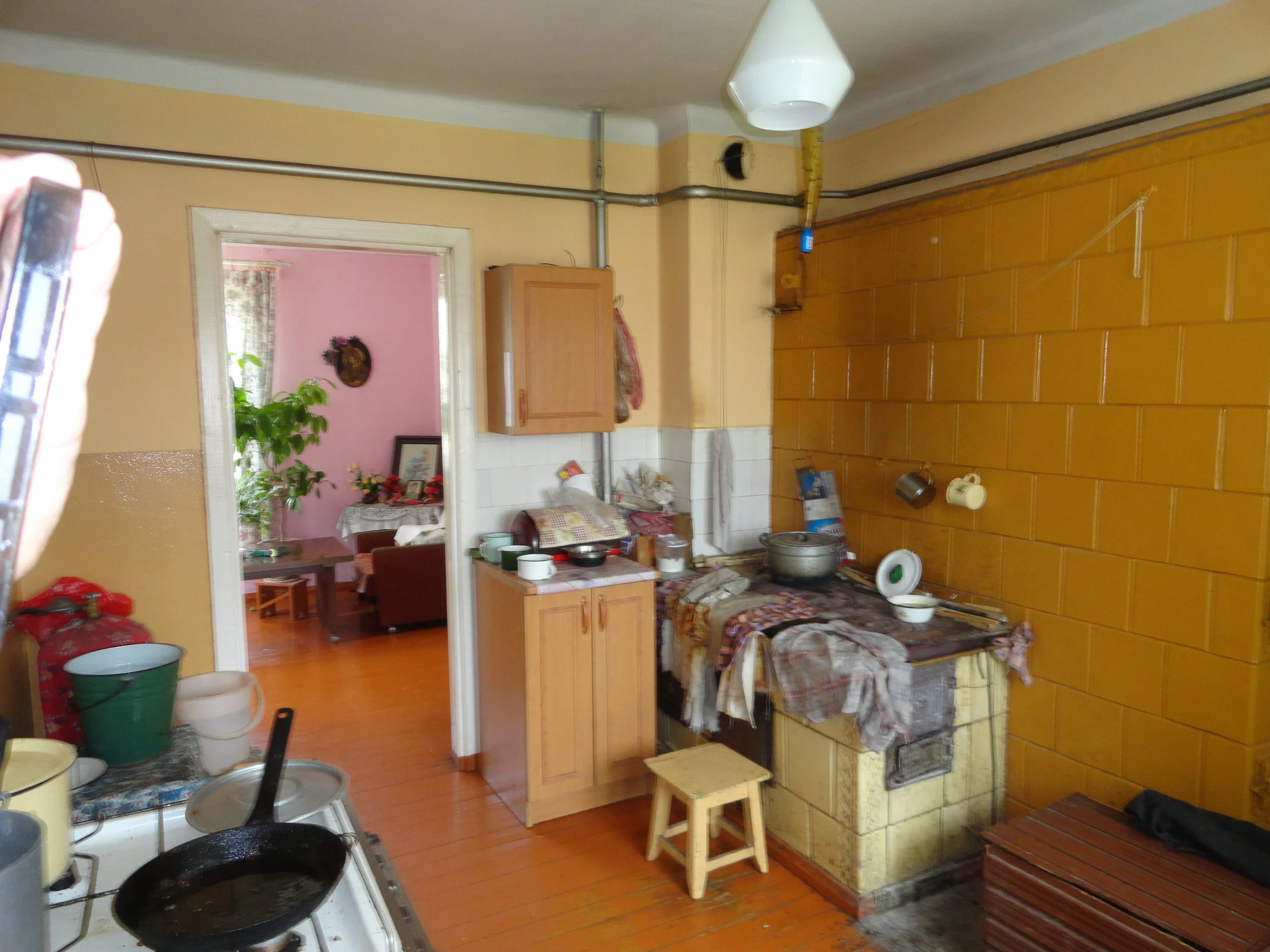 Pranè's kitchen -- she has a modern gas stove so she uses the old wood fired stove as a counter.