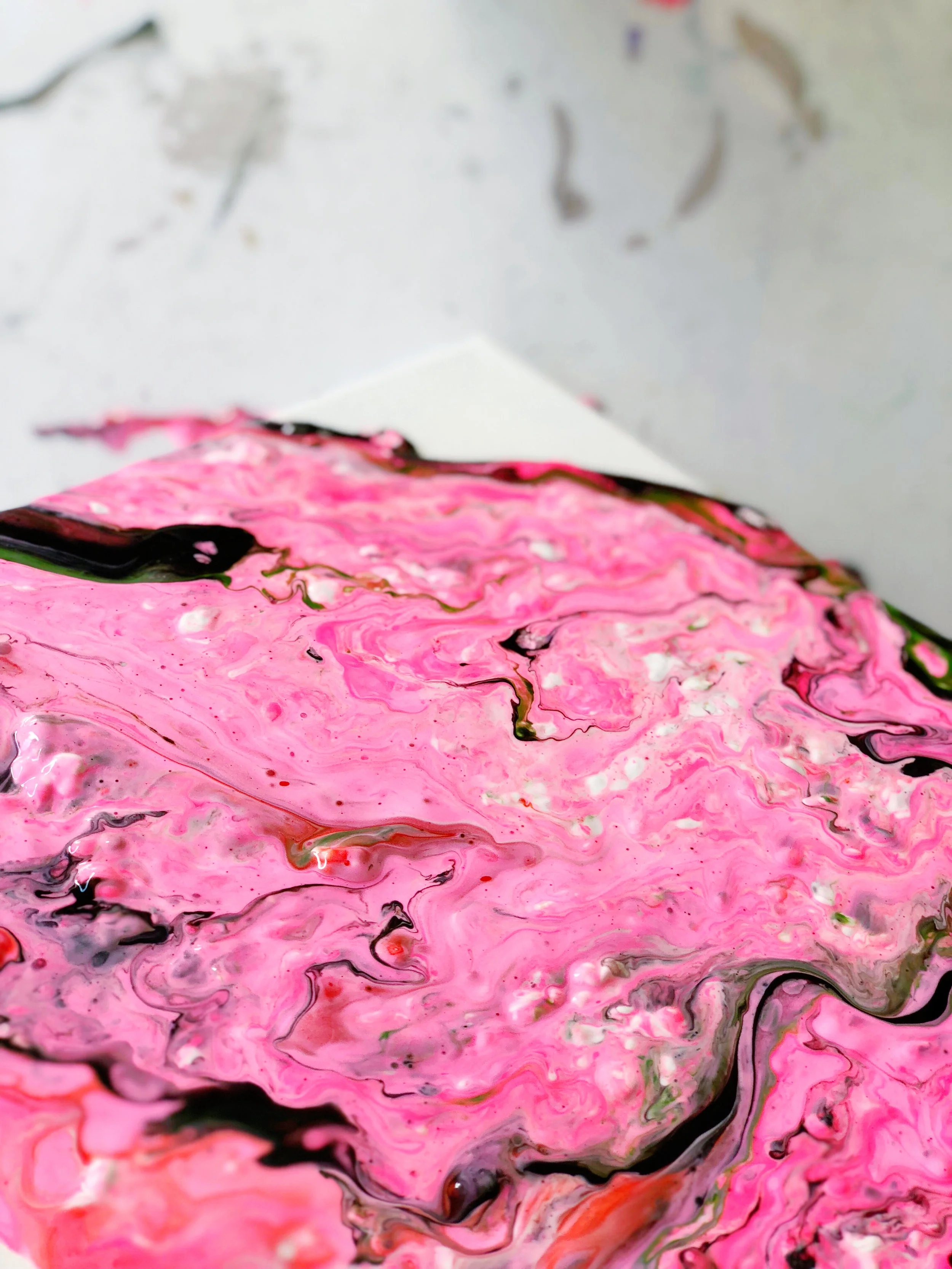 16. You will need to move the canvas from side to side, turn it around, and also tap it on its sides to achieve this look. You will not be able to manipulate the paint with a brush or your fingers, it will turn muddy and brown. It will eliminate the marbling effect you are going for in this project. 