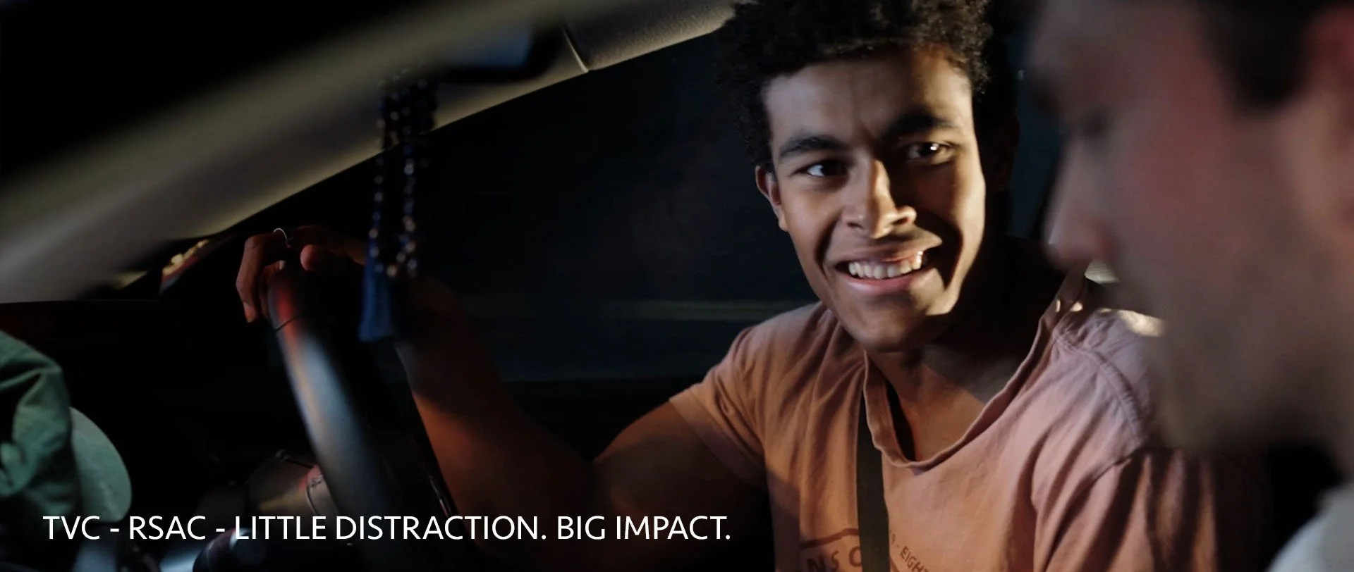 A man distracted in a car unaware he is about to crash