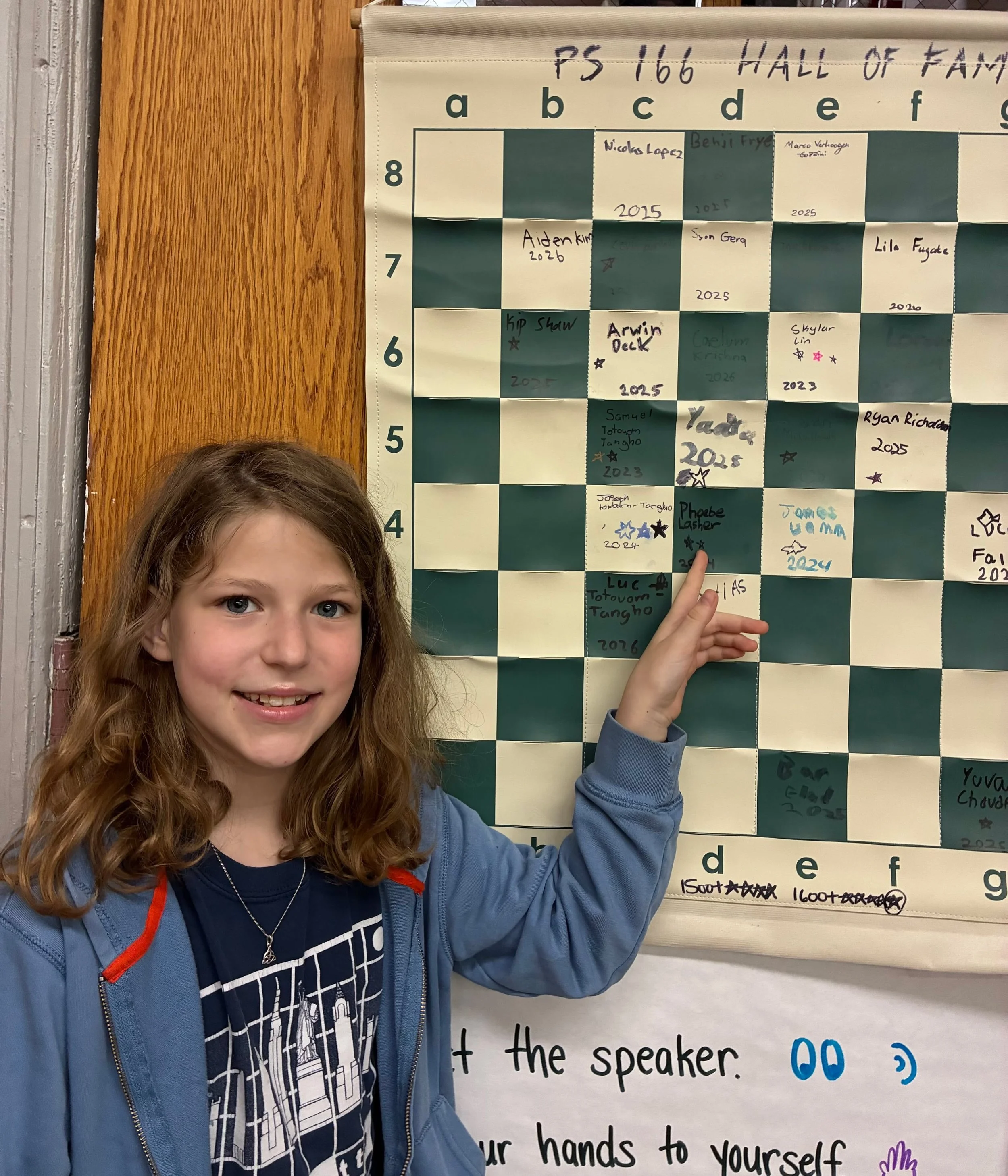 Congratulations to Phoebe from PS 166, who added her second star to the Hall of Fame board for breaking 1400! Phoebe is a tremendous leader of the PS 166 Chess team, and her latest achievement serves as an inspiration for everyone on the team.

#1400