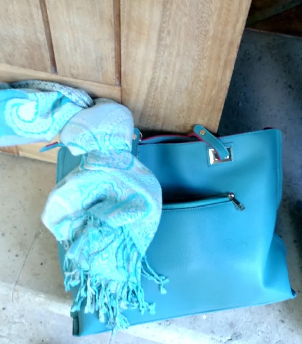 Bring a scarf to keep warm on the plane that doubles as the swimwear wrap at the beach