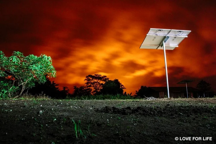 Arausol island solar system in the Amazon region of Ecuador. The burning sky shows the long-distance flaring of the oil production.