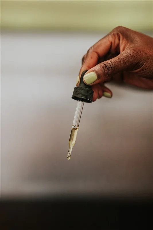 Facial Serum dropper in hand.jpg