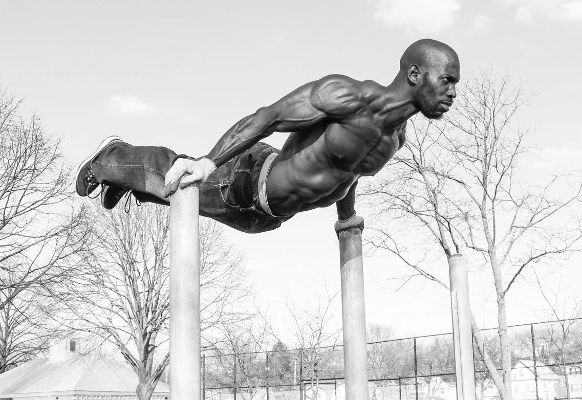 New York's Hannibal Langham performing an advanced calisthenics move: dip to back lever